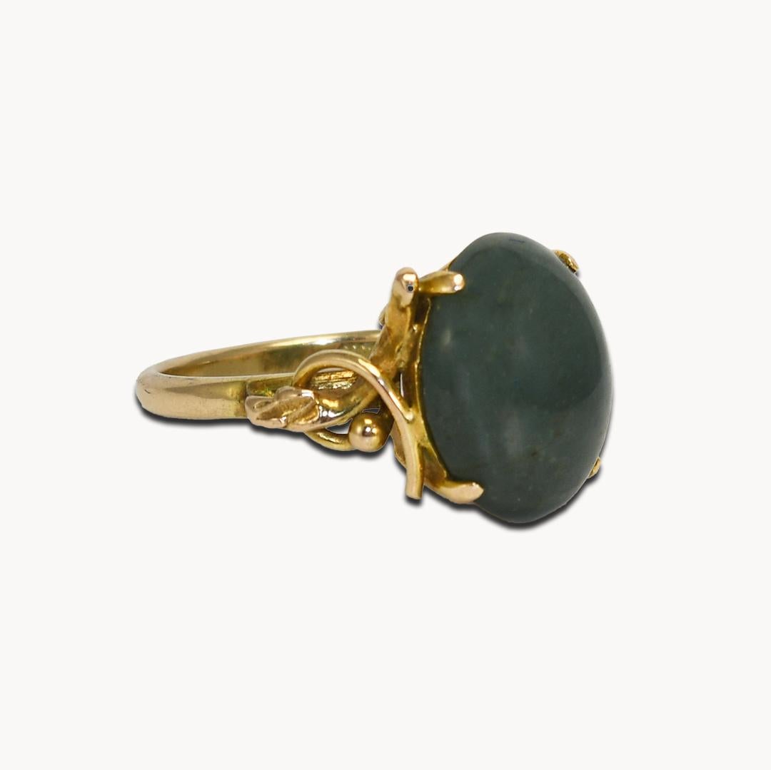 14k Yellow Gold nephrite jade Ring. 
Stamped 14k and weighs 4.8 grams. 
The stone measures 14mm by 10.8mm.
Ring Size is 6 and can be sized up or down one full size or less for an extra fee.
Very good condition.