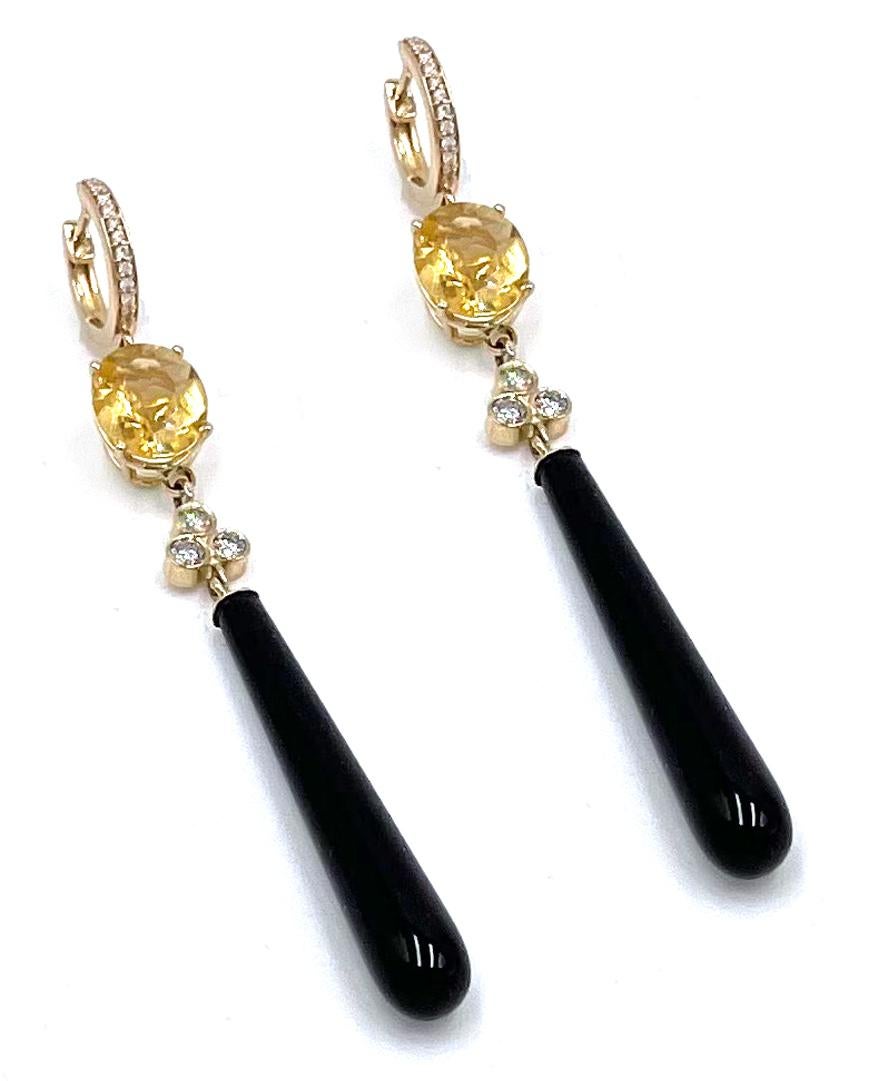 Pair of 14K yellow gold earrings with tear drop black onyx and two oval citrines weighing a total of 4.38 carats. In between the citrine and onyx are a cluster of bezel set six diamonds weighing a total of 0.33 carat.  In the top hoop are pave set