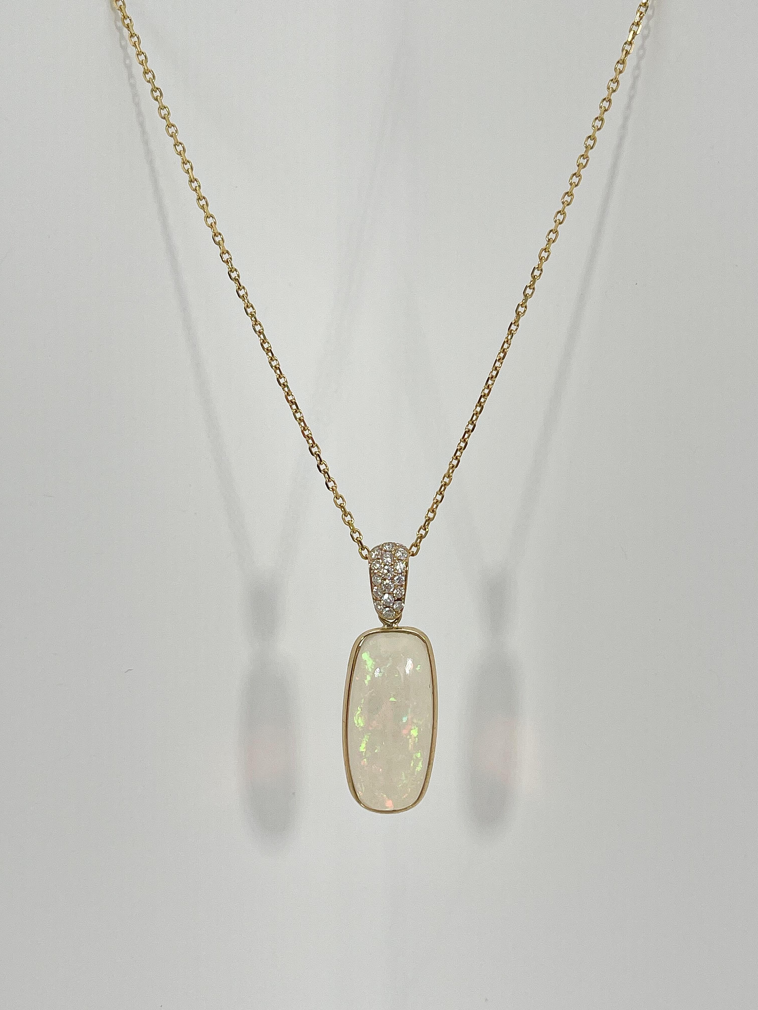 14k yellow gold opal and .22 CTW diamond pendant necklace. The diamonds on the bail are all round, the pendant measures 22 x 10 mm, has a length of 18 inches, and the necklace has a total weight of 4.8 grams.