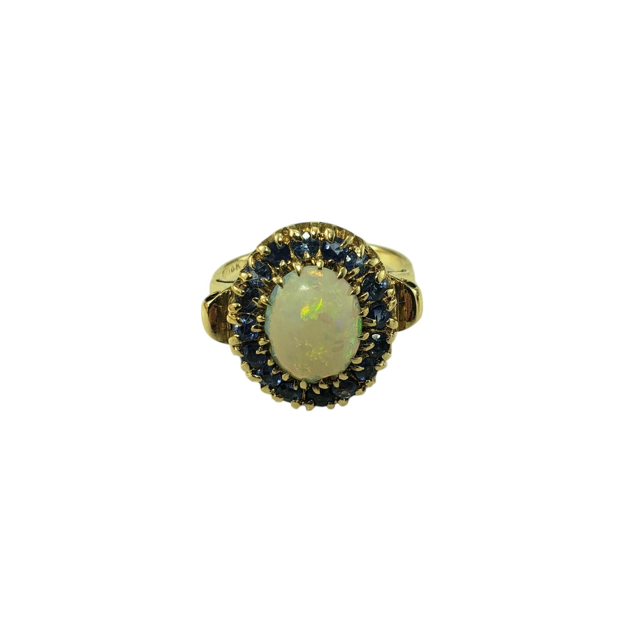 14K Yellow Gold Opal and Blue Sapphire Ring Size 5.5

Step into a world of whimsy with this 14K yellow gold ring that’s equal parts celestial and chic. Featuring a dreamy opal center (10 mm x 8 mm) that shimmers like bottled moonlight and natural