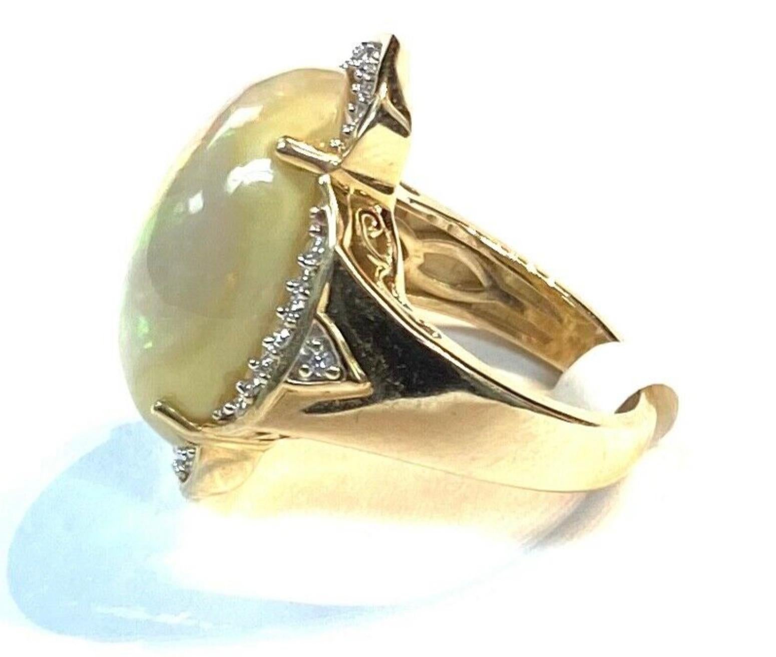 Beautiful 14k yellow gold opal encircled with diamonds ring.  7.15 Grams TW. The dimensions of the opal are approximately 13 mm x 20 mm. Approximately 8 carats. Marked 14K. Approximate size 4.5.