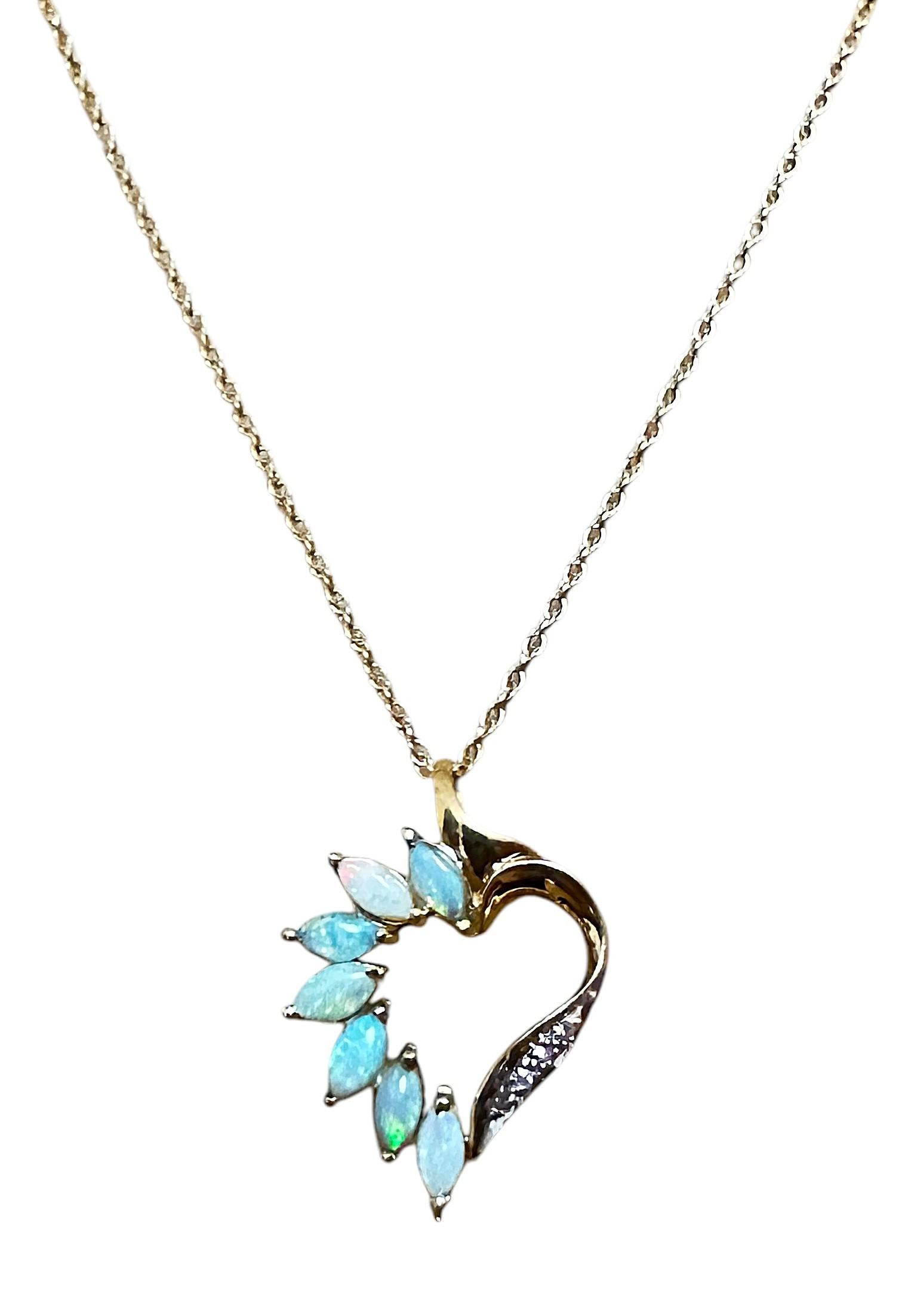 This is really a beautiful Opal pendant.  The opals have a wonderful color to them.  There are 7 marquise cut opals and the largest measures 6 x 3 mm.  There are also   4 brilliant cut 1 mm diamonds on the pendant.  The back of the pendant is