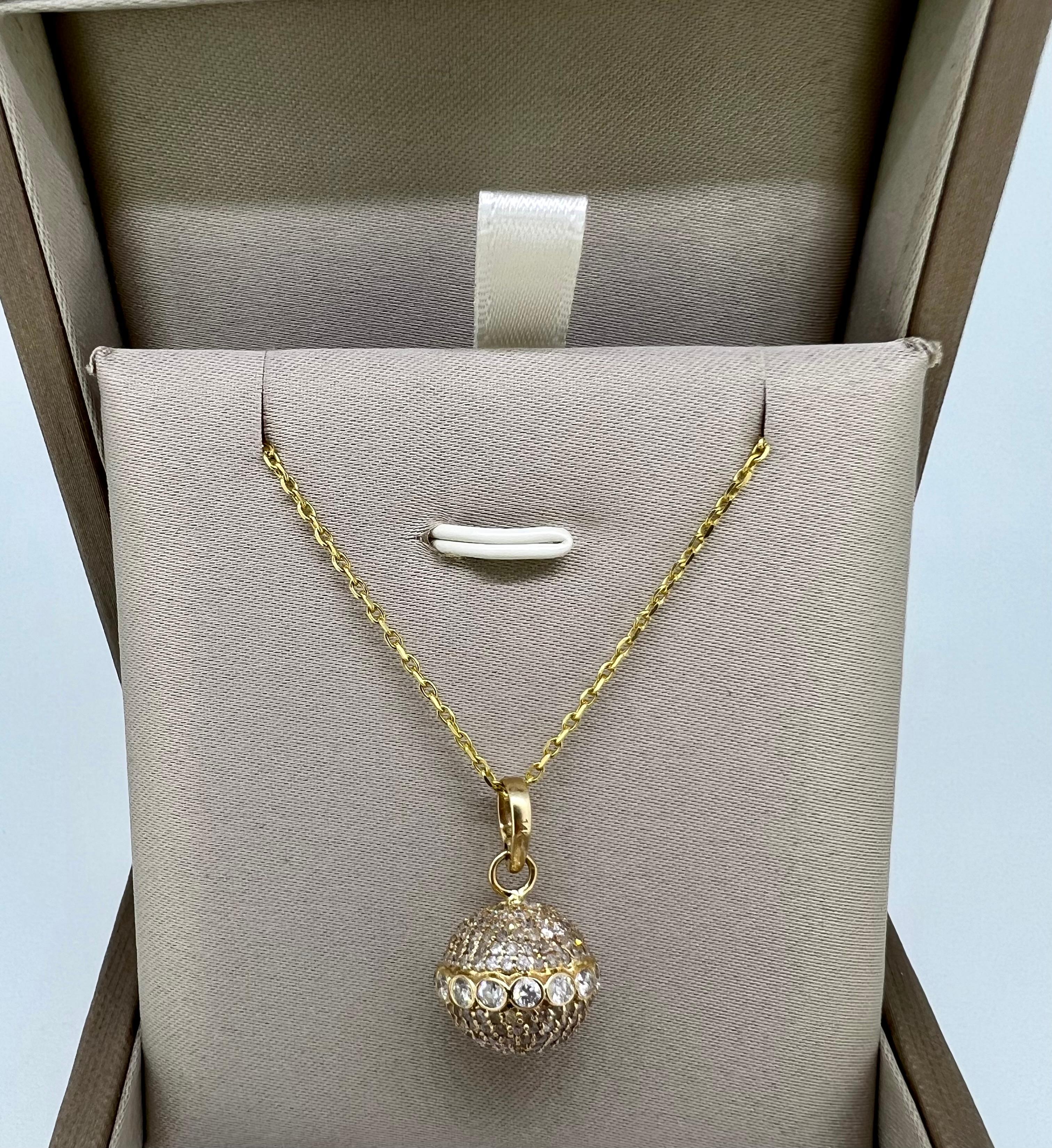 
This beautiful yellow gold necklace showcases the a dazzling diamond orb with a large belt and a double-sided diamond-encrusted clasp. Designed for elegance this light delicate, made-to-last necklace can easily be paired with other necklaces or