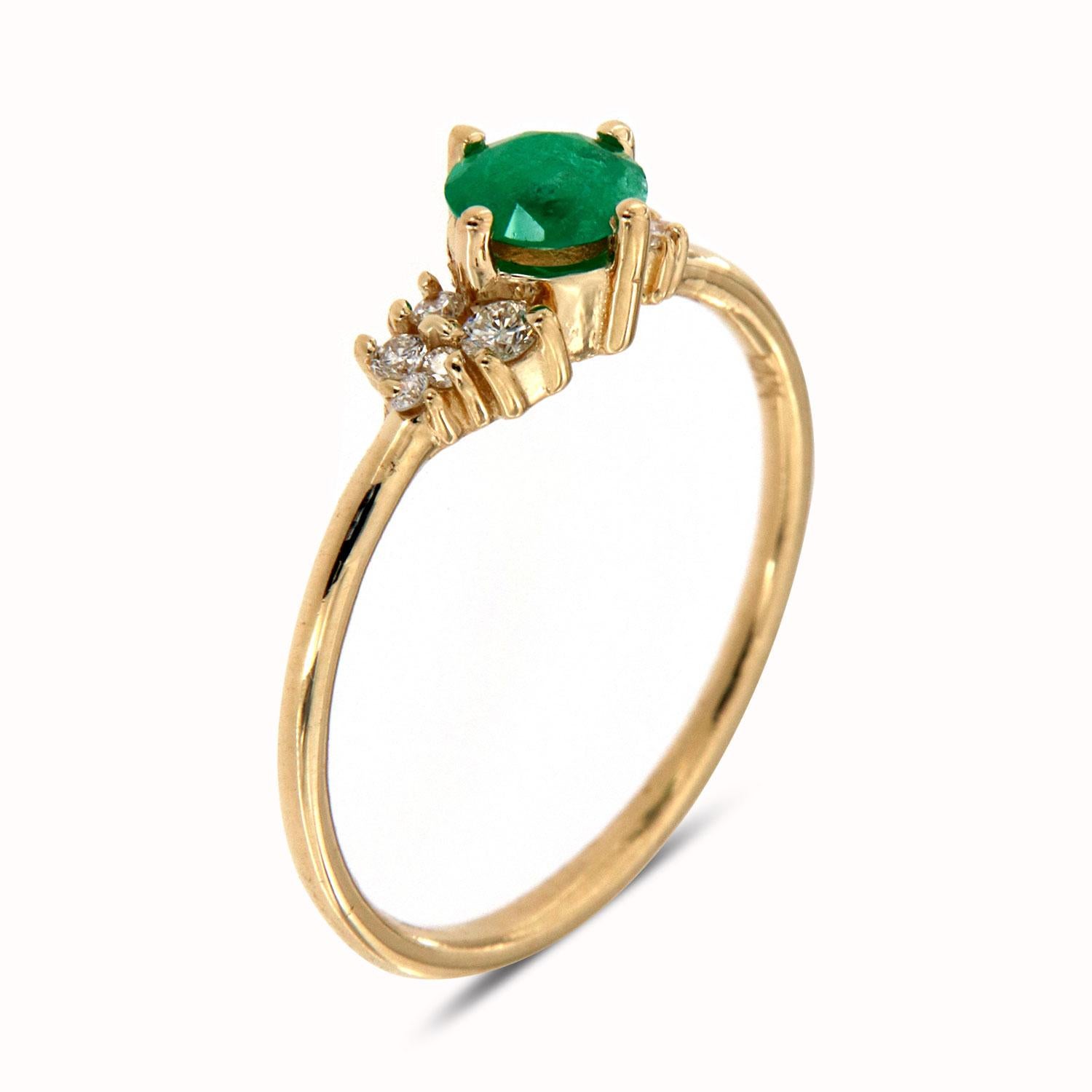 1This delicate ring features Seven(7) round diamonds scattered on top of a 1.2 mm band. In the center of the ring is set one Natural Green Emerald 0.27-Carat weight set in tiny prongs that enhance this ring's organic and earthy look. Experience the