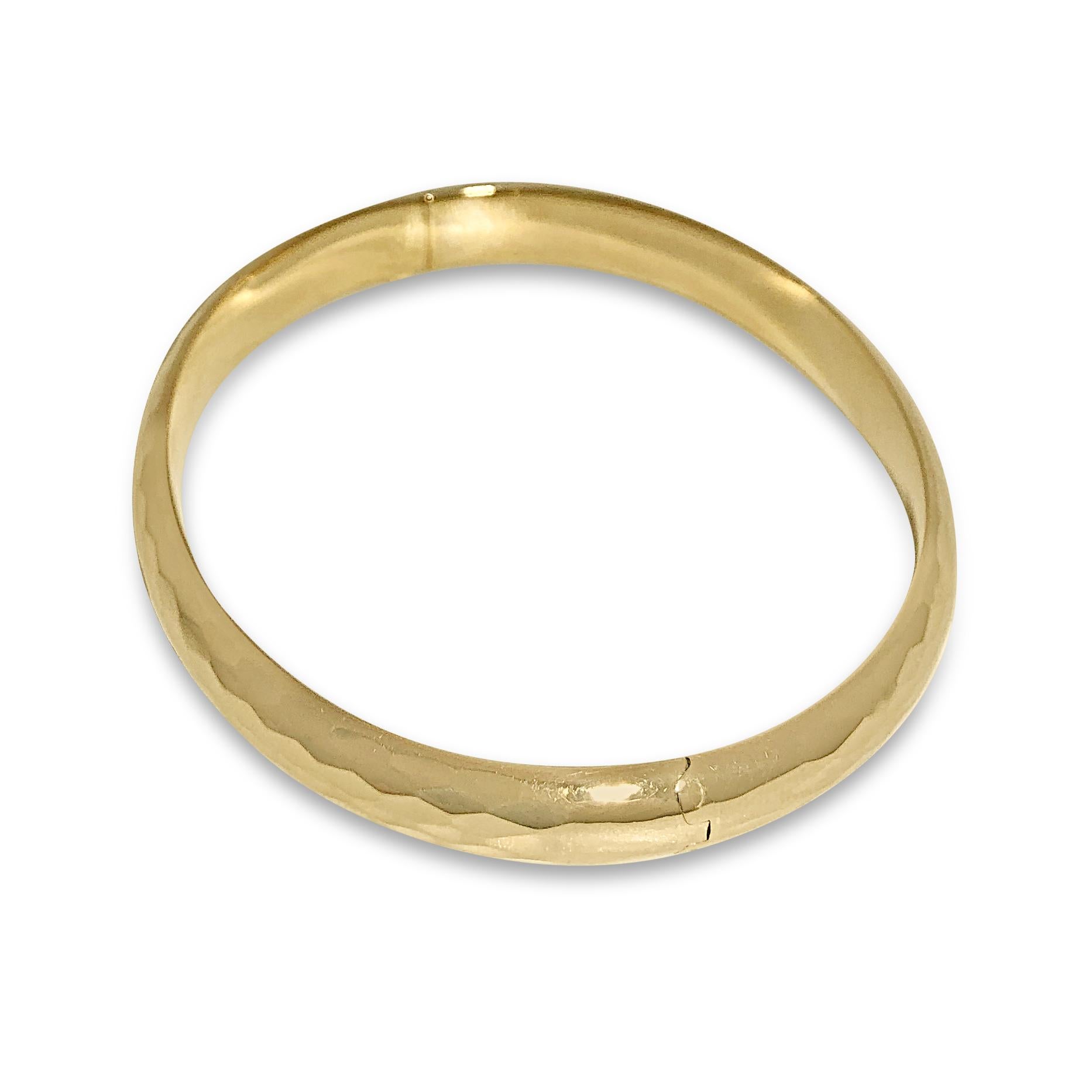 Our high-polish 14K yellow gold hammered cuff bangle is fashionably faceted to catch the light from every direction. The oval-shaped bangle measures 5/16” wide with a snap & hinge closure.

Specifications:
- Shape: Oval
- Dimension: 6 5/8