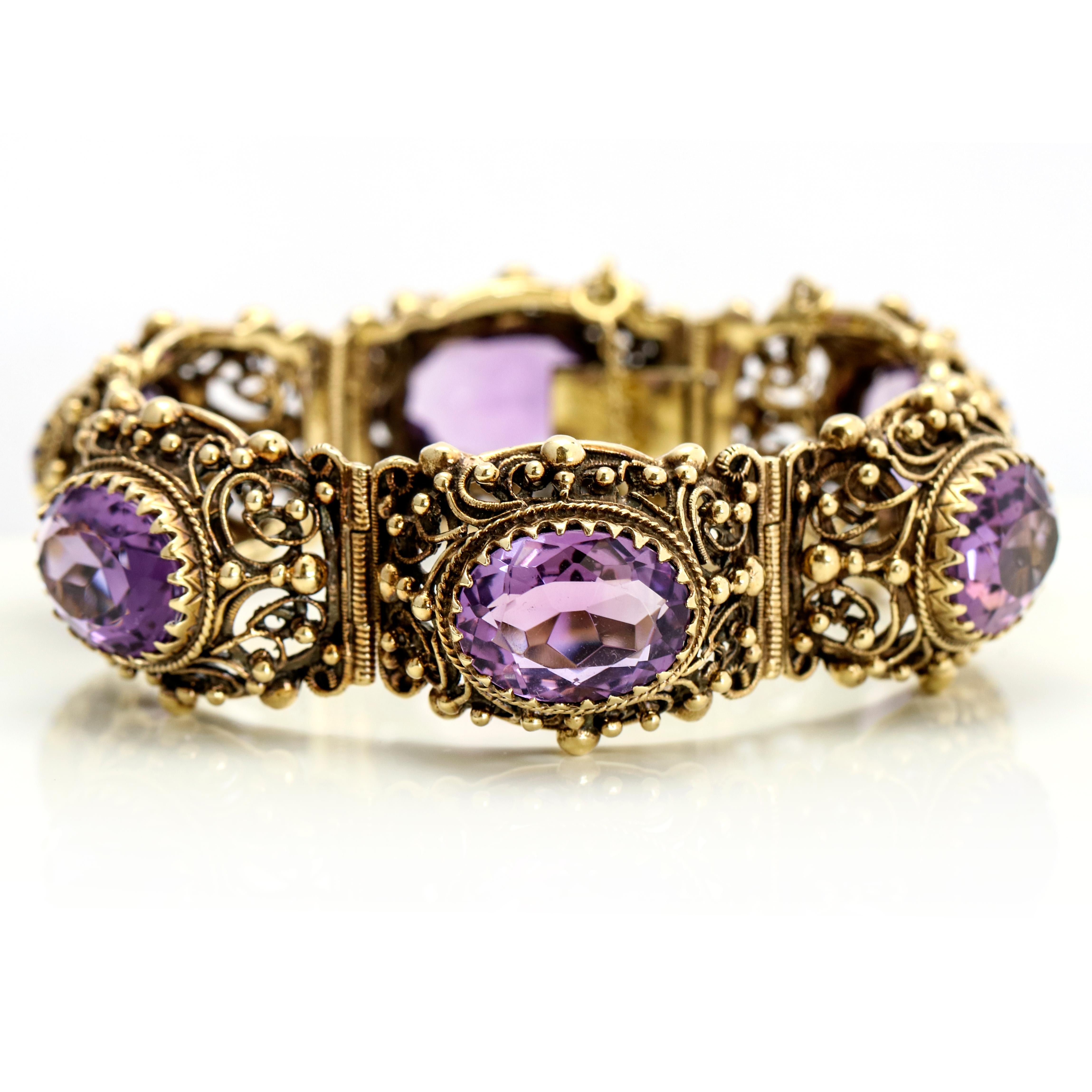 Victorian style statement bracelet in 14-karat gold with oval-cut natural amethyst. The bracelet is signed with a letter A inside a shield. The A mark appears on the back of each link. Slide clasp with safety chain. Size medium, fits a wrist up to 6