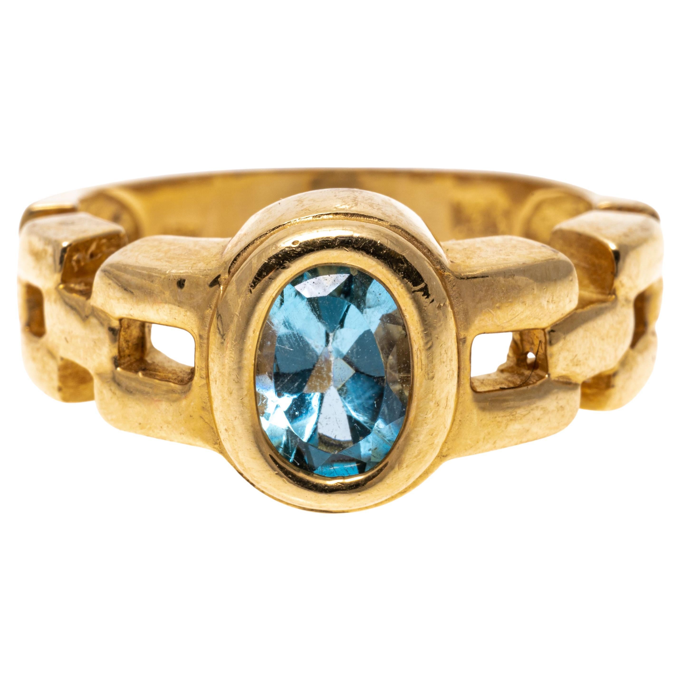 14k Yellow Gold Oval Blue Topaz and Chain Motif Ring, App. 1.01 CTS For Sale
