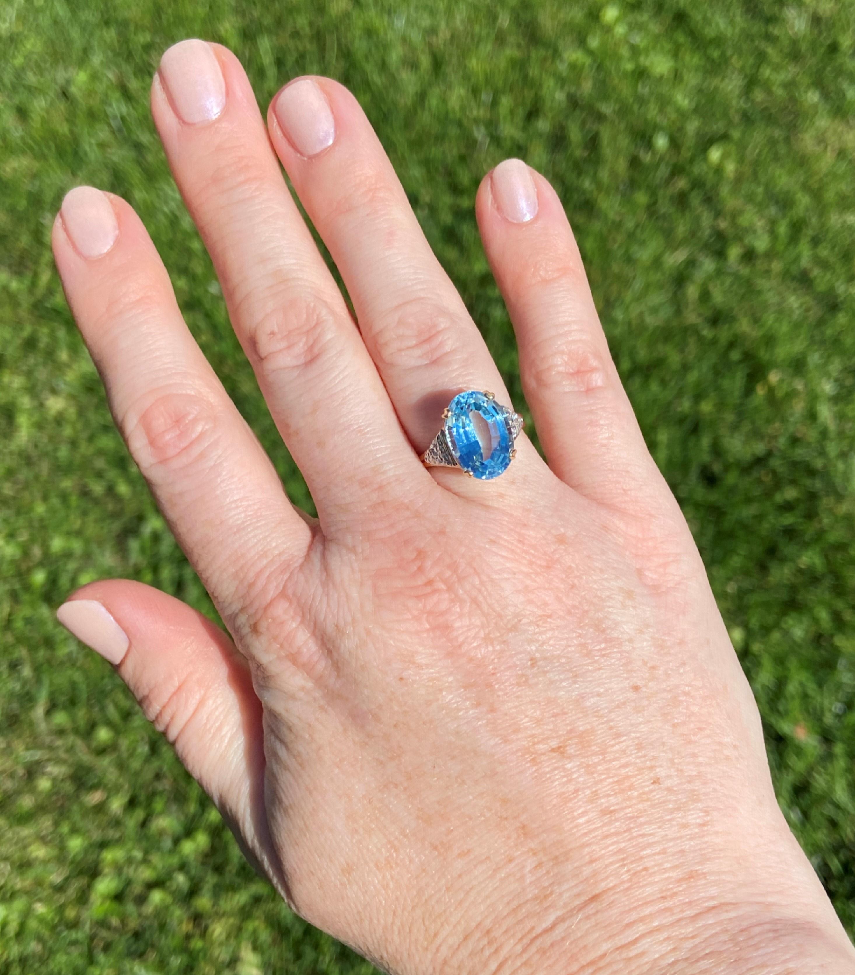 A stunning 6.22ct oval cut sky-blue topaz sits proudly at the center of this gorgeous ring. On either shoulder is a triangle-shaped section of white gold set with .05tcw H-I color, SI2-SI1 clarity diamonds for some added sparkle. The color of this