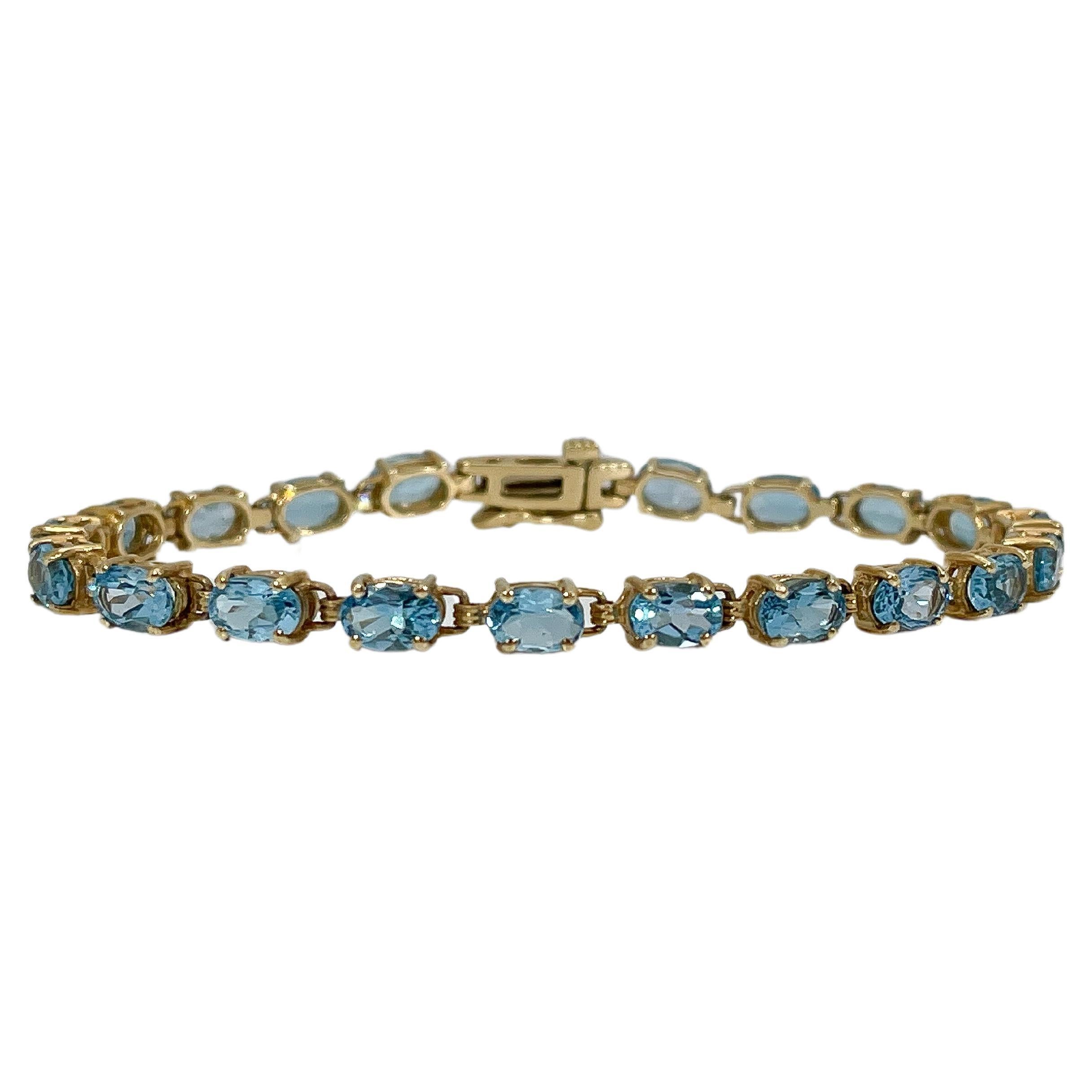 Bracelet en or jaune 14 carats avec topaze bleue ovale