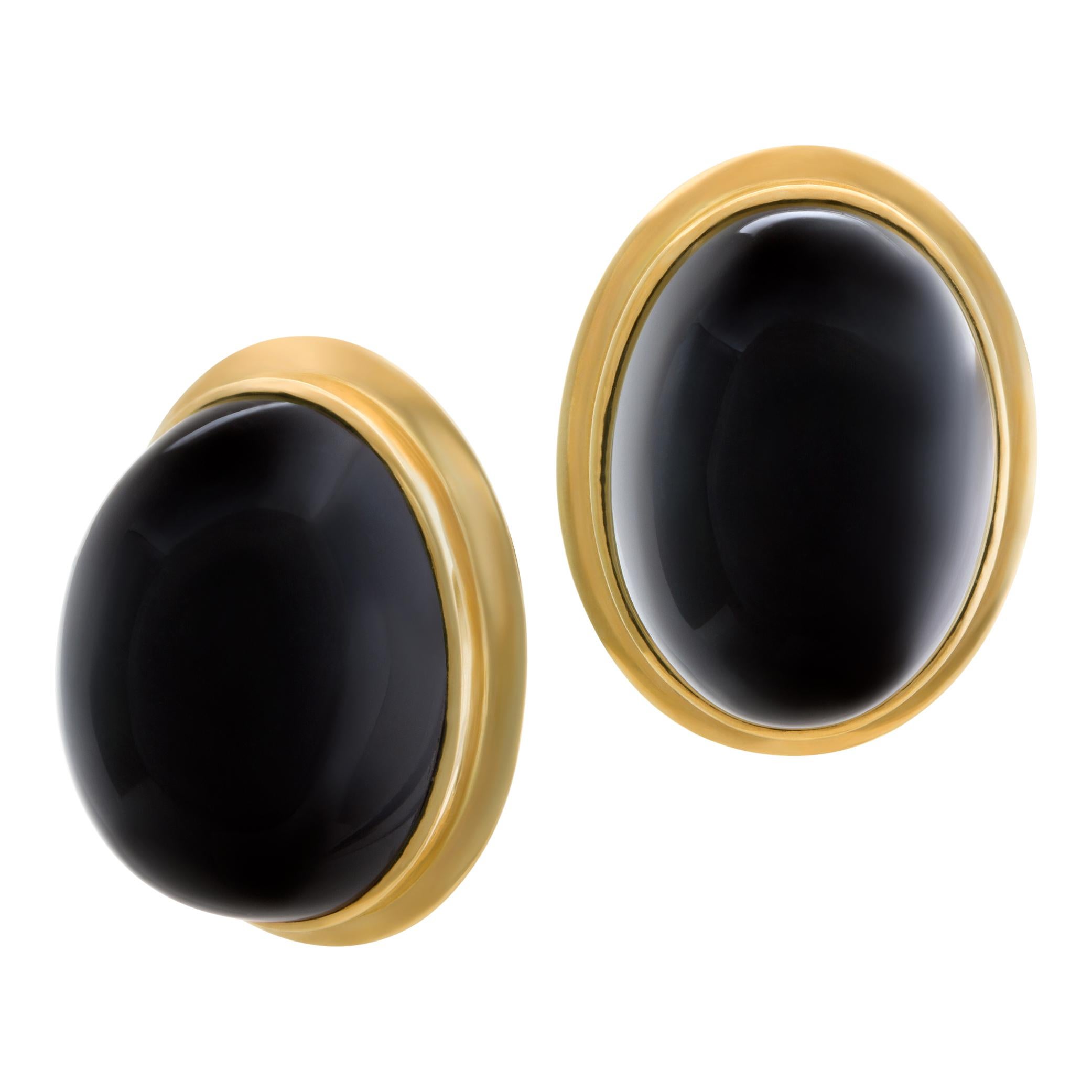 Large oval cabochon onyx earrings in 14k yellow gold. Hanging length 1.00 inch. Width 21.5mm. Onyx cabochon dimensions: 17.5mm width x 23.5mm length and 14mm deep. Omega clip with post. .
