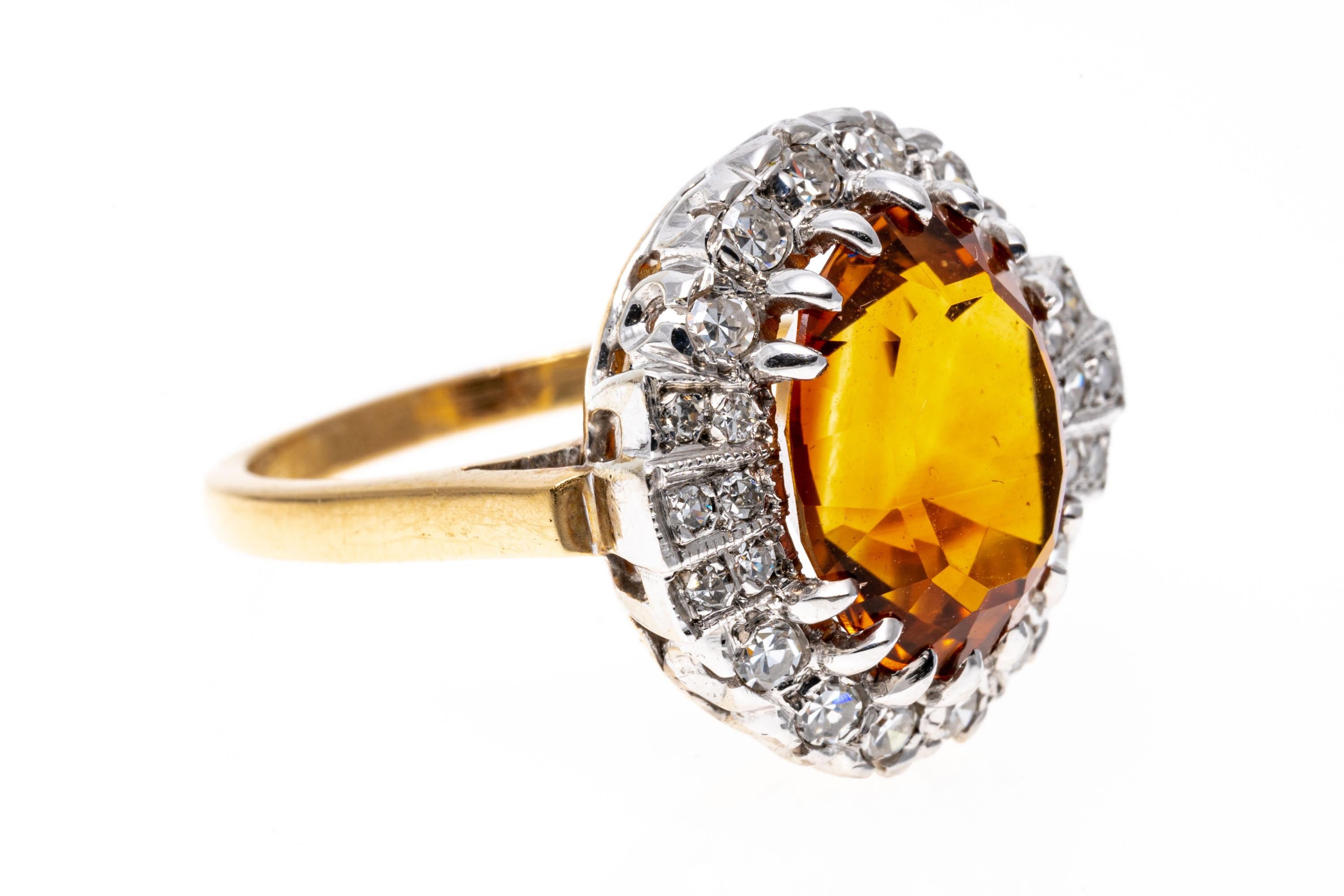 14k yellow gold ring. This lovely ring features a center oval faceted, medium to dark orange color citrine, approximately 3.95 CTS, accented by a half halo set with round faceted diamonds, and flanked with fan sides, also set with round faceted