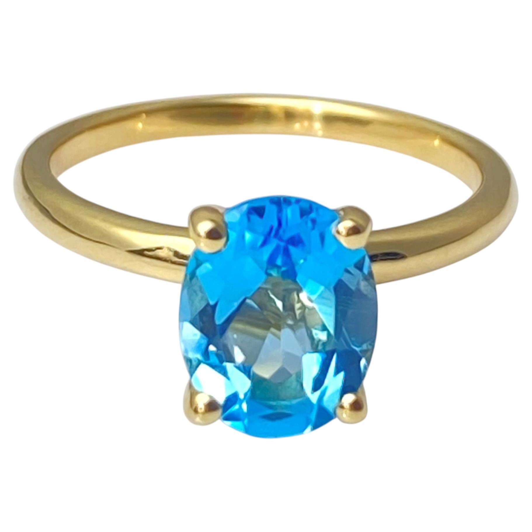 Anello solitario in oro giallo 14K con taglio ovale di topazio blu svizzero