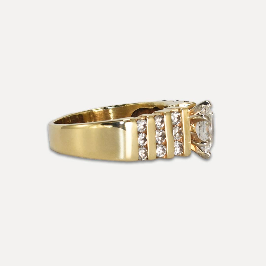 Ladies' diamond engagement ring in 14k yellow gold setting.
Stamped 14k and weighs 5.7 grams gross weight. 
The center diamond is a .90 carat oval shape, H- i color, i1 clarity.
In channel settings on the sides are round brilliant cut diamonds, .50