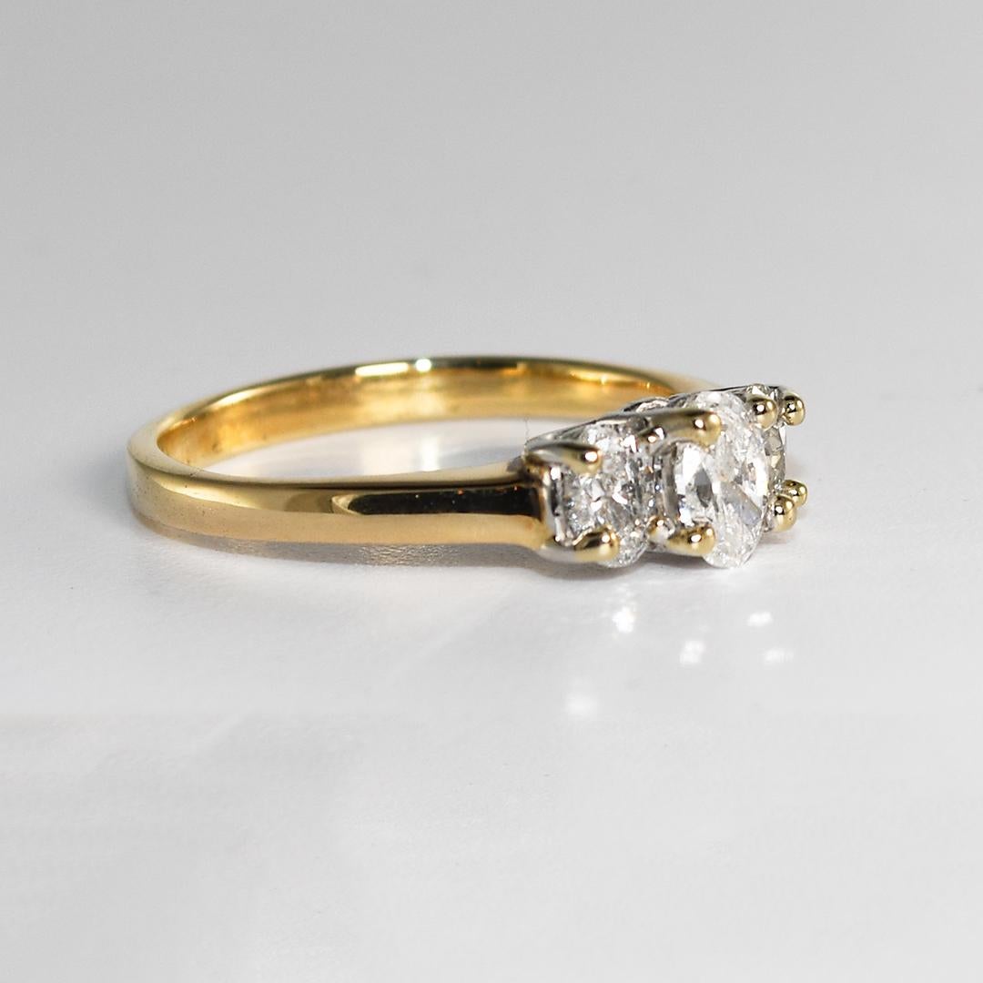Ladies 3 oval diamond ring in 14k yellow.
Stamped 14k and weighs 3.8 grams.
The center diamond is .46 carats, G, H, I color range, i1 to i2 clarity,  good cut.
The side diamonds are ovals, .30ct each, H, I, color range, i1 clarity. 
The ring size is