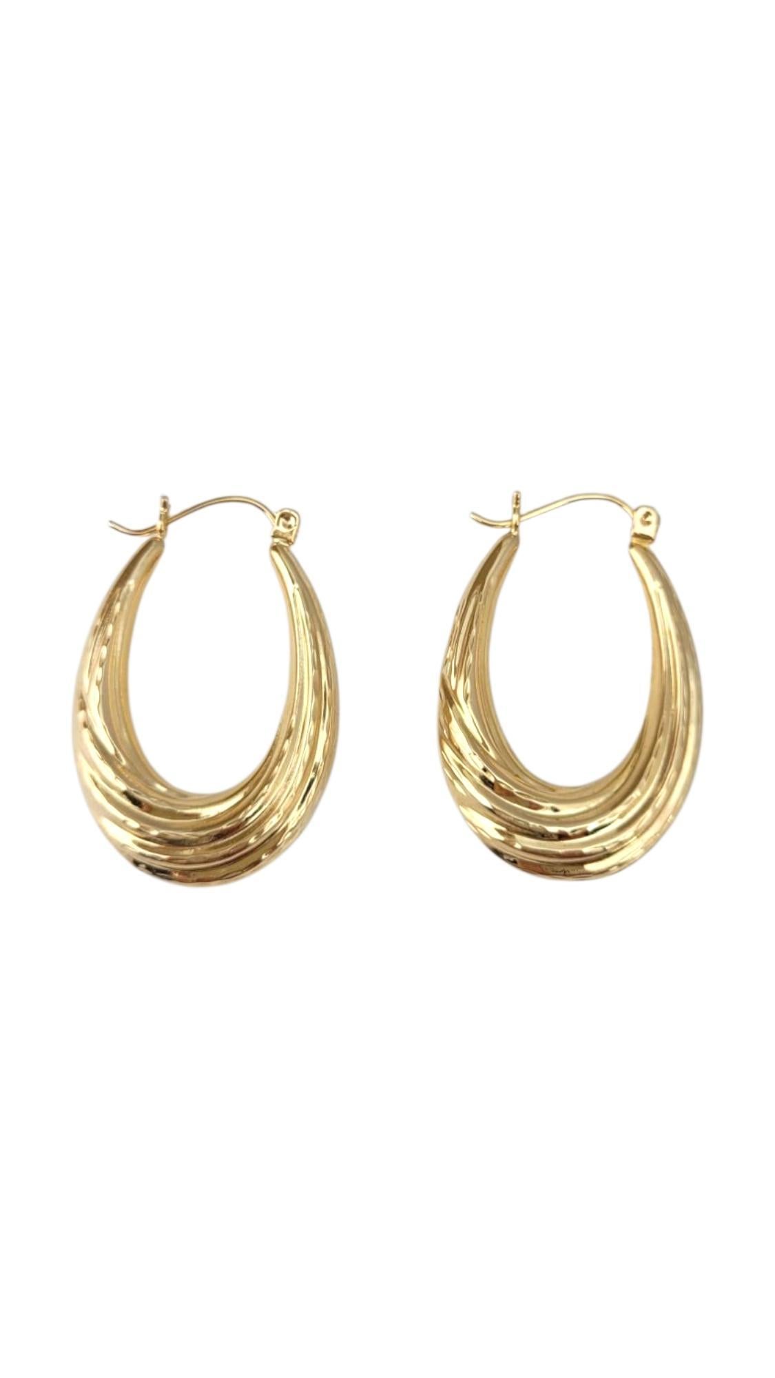 14K Yellow Gold Oval Hoop Earrings -

These gold oval hoop earrings offer a refined twist on the classic hoop with their elongated, elegant shape. Crafted in radiant gold, they bring a touch of sophistication and modern style to any outfit—perfect