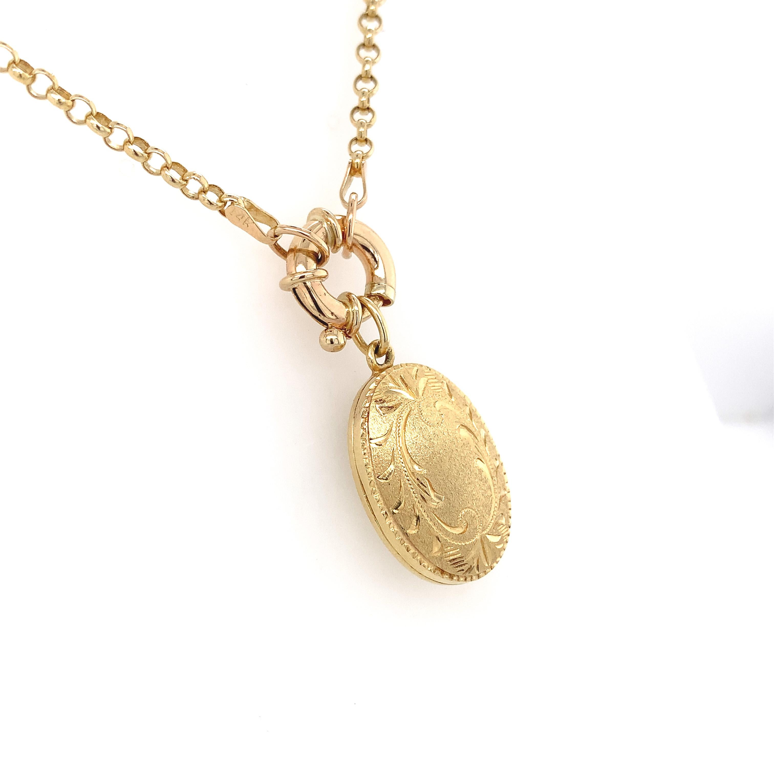 14K yellow gold oval locket on a 14K yellow gold fancy rolo link chain. The locket measures 1 1/8