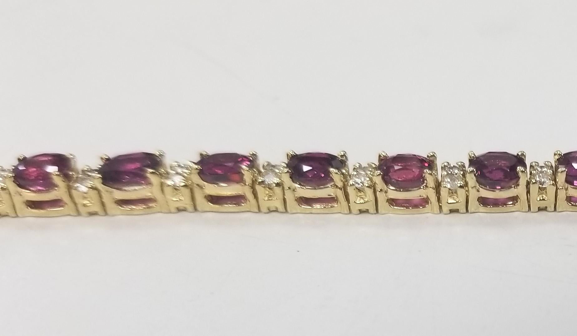 14k yellow gold oval ruby and diamond bracelet, containing 25 oval rubies of gem quality weighing 10.78cts. and 50 round full cut diamonds; color 