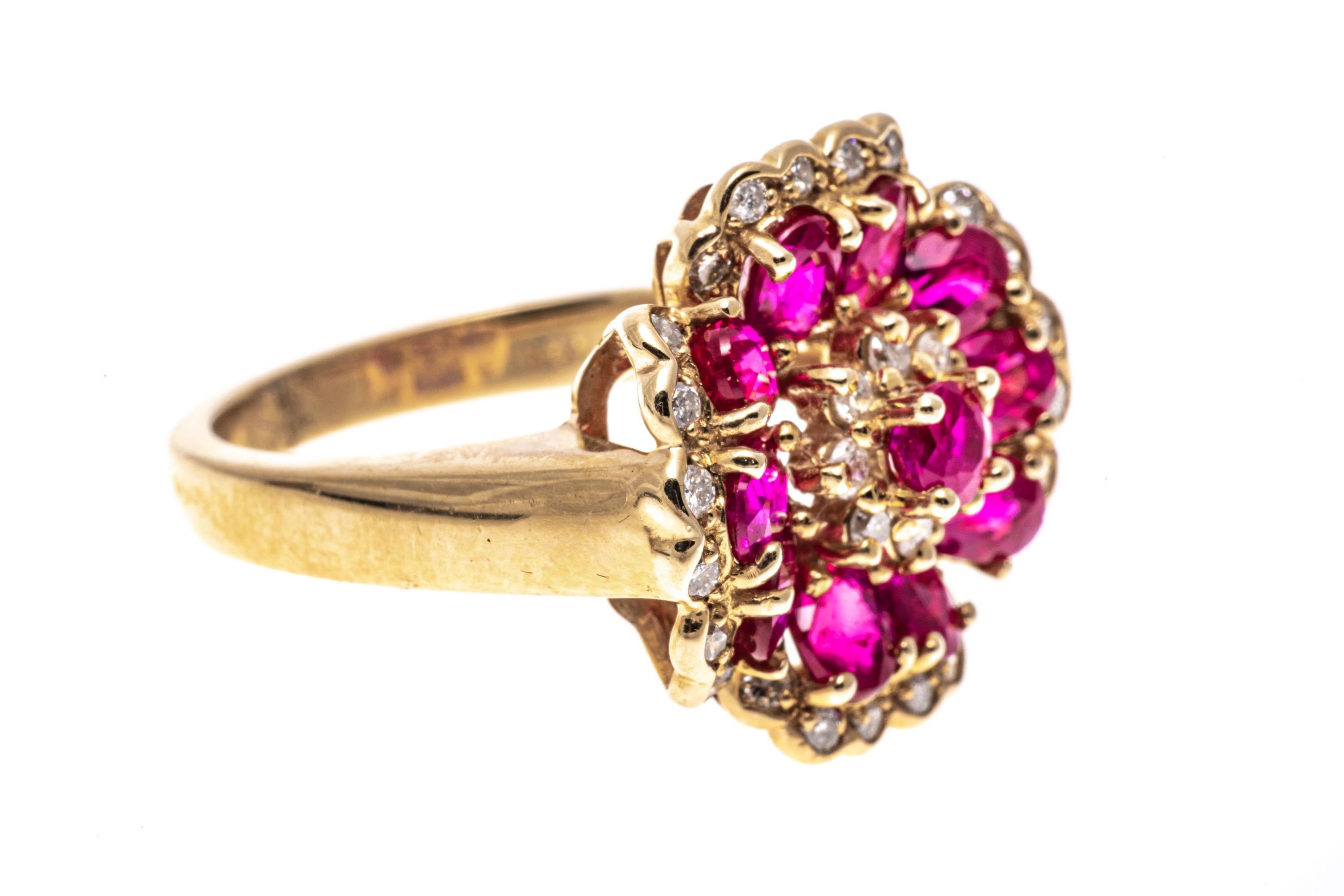 14k yellow gold ring. This beautiful flower motif ring is cent with a center round faceted, reddish pink ruby, approximately 0.19 CTS, decorated with a round faceted halo. Framing the halo is a border of angled, oval faceted, reddish pink color