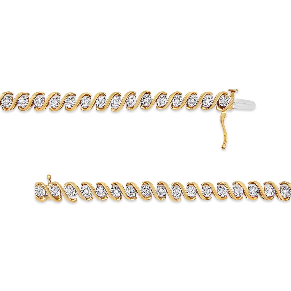 The pinnacle of high style, this fascinating tennis bracelet dazzles with round diamonds designed with a unique, stone enhancing miracle plate setting. A polished 14k yellow gold plated .925 sterling silver wraps the diamonds in a poised beauty that