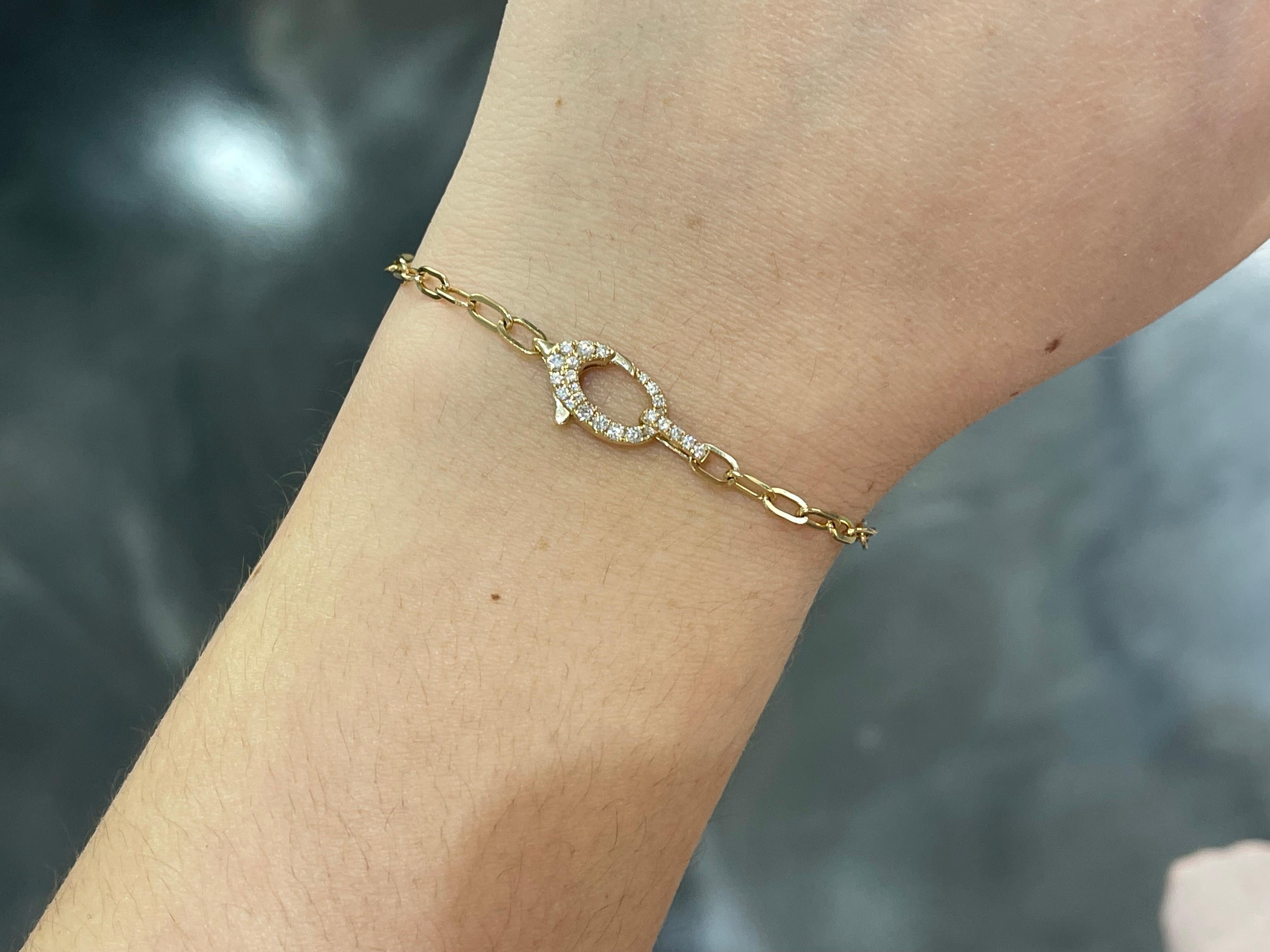 14k yellow gold paperclip bracelet with .24 CTW diamond clasp. The diamonds in this bracelet are all round, the bracelet measures to be 7 1/4 inches long, the clasp measures to be 14.5mm x 7.5mm, and it has a total weight of 3.6 grams. 