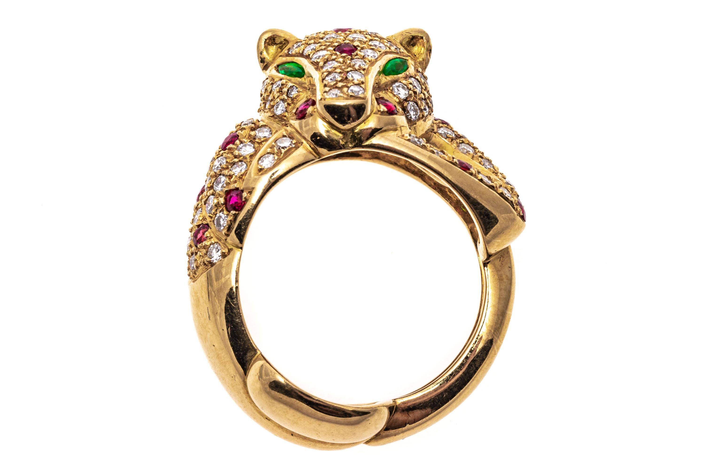 14k yellow gold ring. This beautiful, classic ring is a yellow gold, figural leopard motif, pave set with round faceted diamonds, approximately 1.44 TCW and punctuated with round faceted, red color ruby spots, approximately 0.60 TCW. The ring is