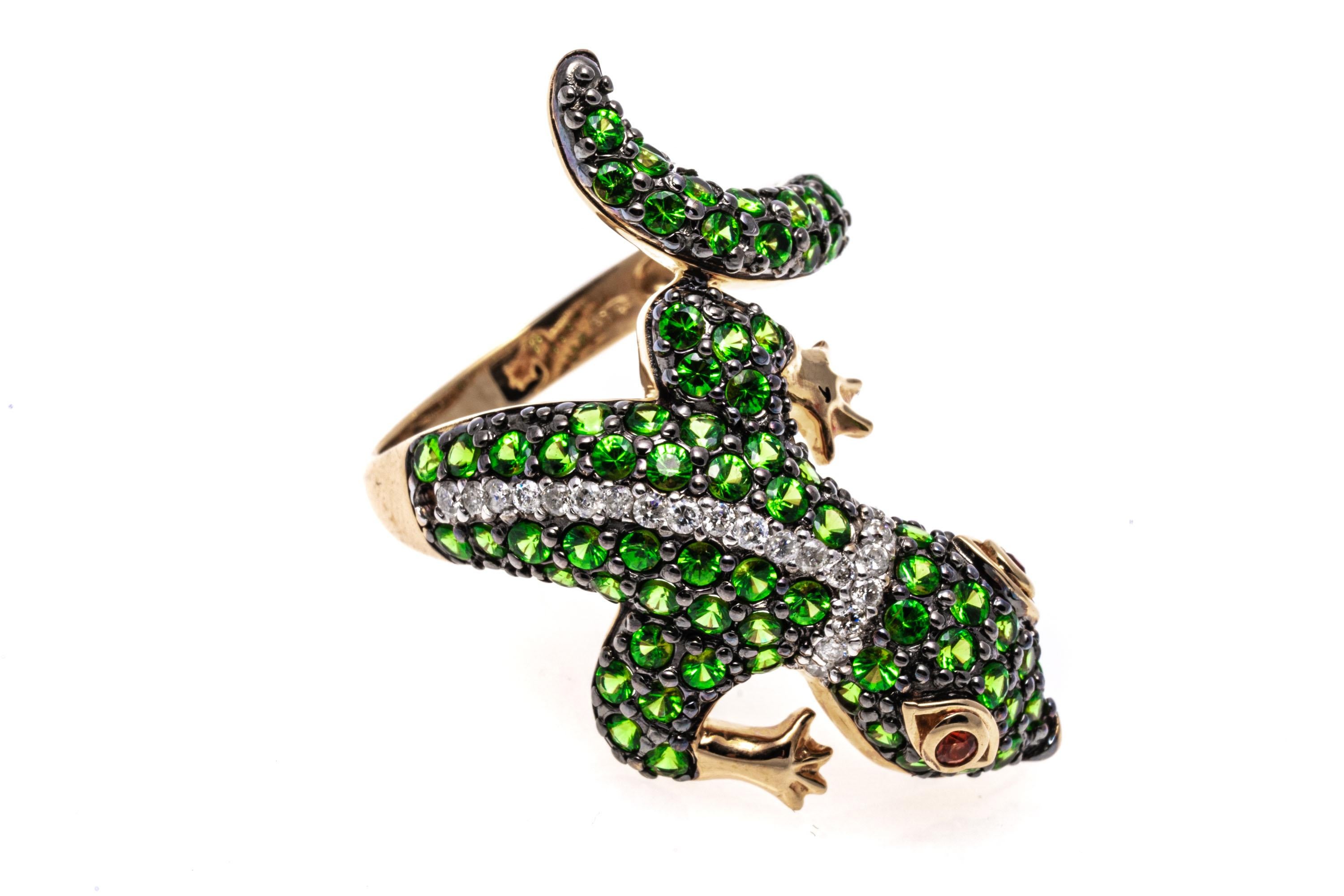 14k yellow gold ring. This beautiful bypass ring is a figural lizard, with the head on one side offset from the tail,  pave set with round faceted, green tsavorite garnets, approximately 1.74 TCW and highlighted with two bands of round faceted,