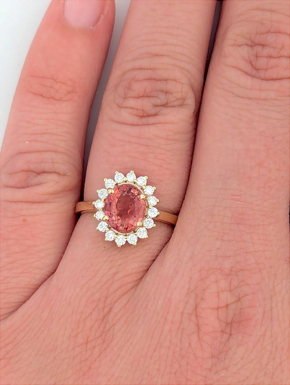 This 14K yellow gold ring features a stunning Peach Tourmaline, celebrated for its soft, warm hues. The delicate beauty of the centerpiece is enhanced by .35 CTW natural diamonds, adding brilliance and sophistication. Designed for those who