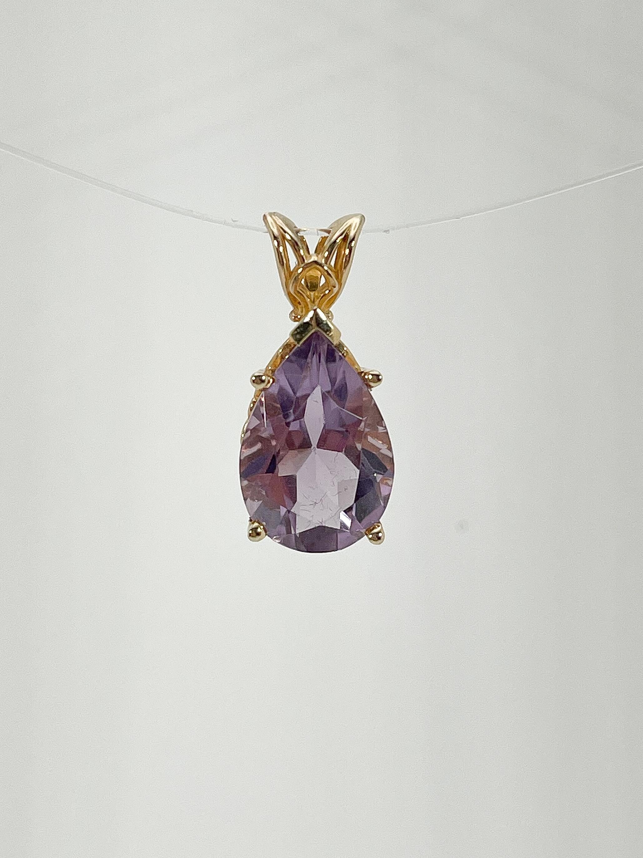 14k yellow gold pear amethyst pendant. Engraved detailing on the sides, the pendant measures 10 x 17 mm, the inside bail measures 4 x 7 mm, and the total weight of the pendant is 2.9 grams. Pendant comes alone, necklace not included.