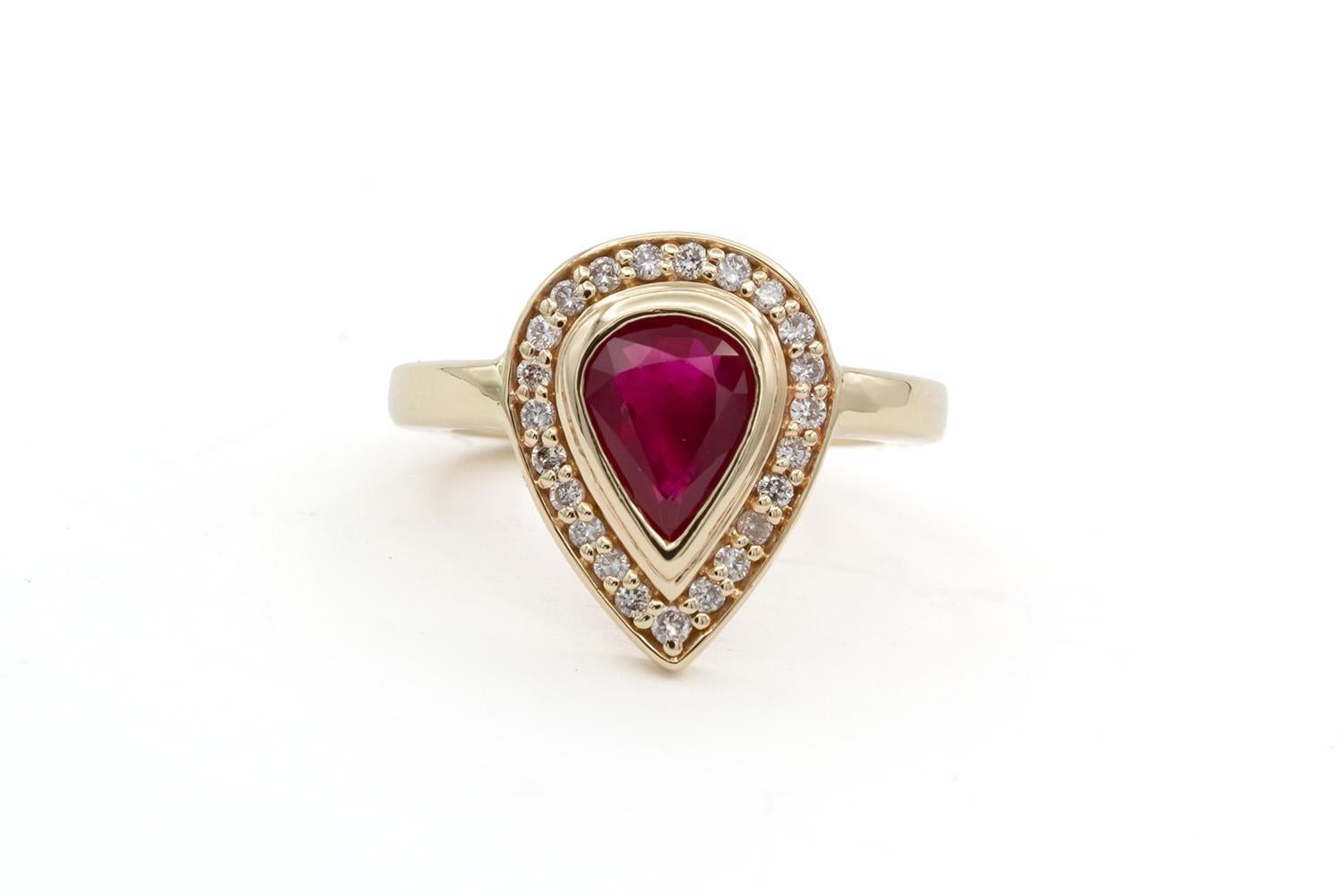 We are pleased to offer this 14k Yellow Gold Ruby & Diamond Ladies Cocktail Fashion Ring. This beautiful and fun ring features an estimated 1.00ct pear cut ruby with a halo of round brilliant cut diamond estimated at 0.35ctw H-I/SI1-SI2 diamonds set