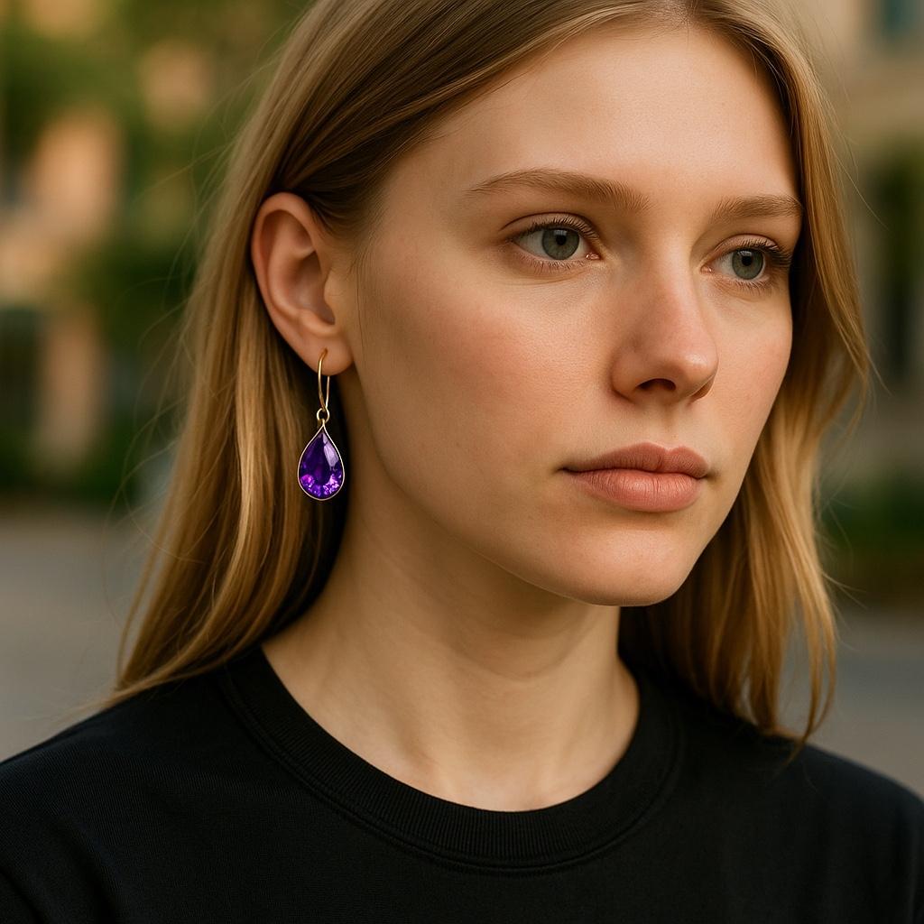 Vibrant Fusion of Color and Classic Elegance
Elevate your style with these 14K Yellow Gold Drop Earrings, showcasing matching pear-shaped amethysts that beautifully catch and reflect light. Their delicate balance of warmth from the gold and the