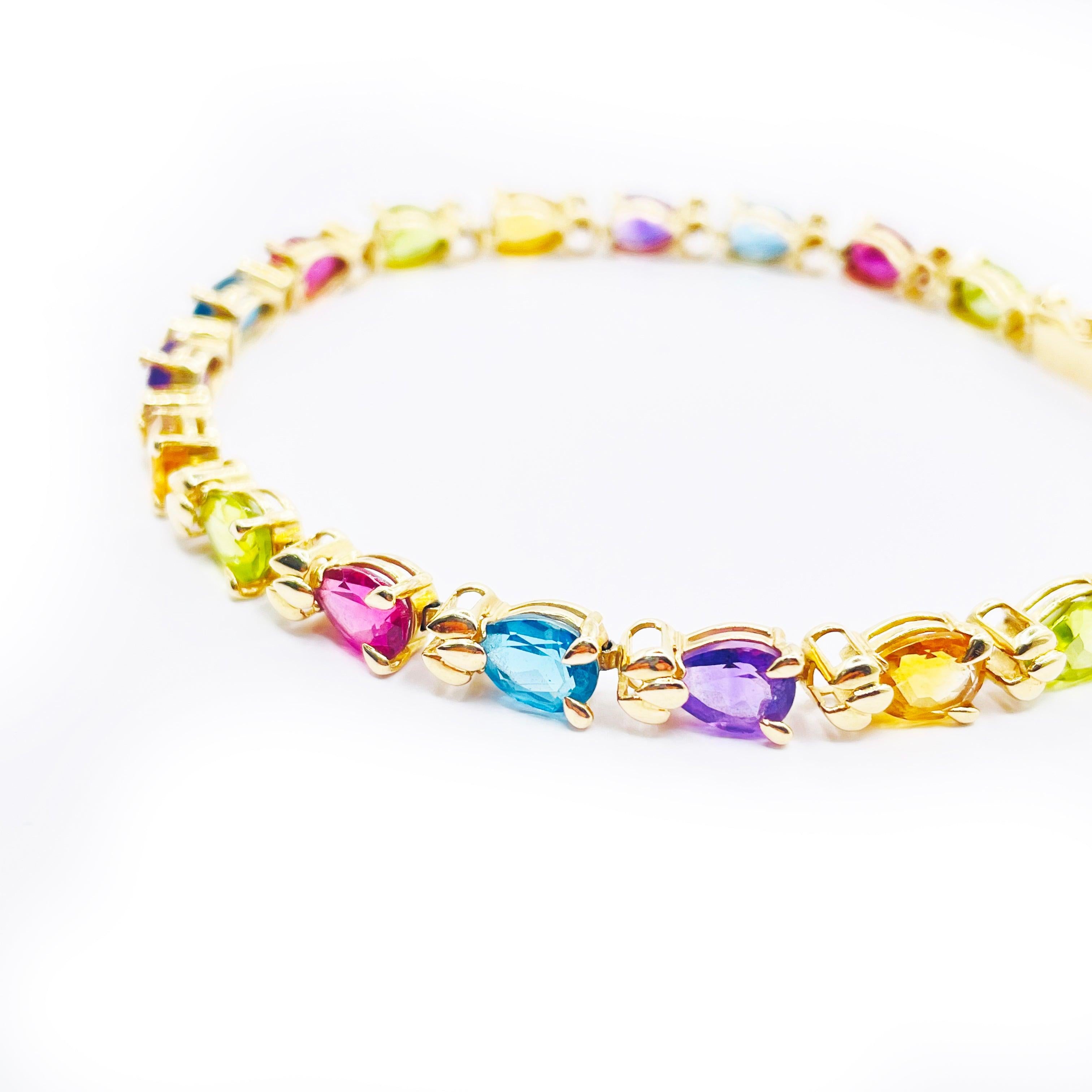 Add a touch of luxury to your look with this exquisite 14K yellow gold bracelet. Featuring a unique pear shape with multi-colour gemstones, this bracelet is sure to make a statement. 

The 10.9-gram weight ensures lasting durability and quality.

