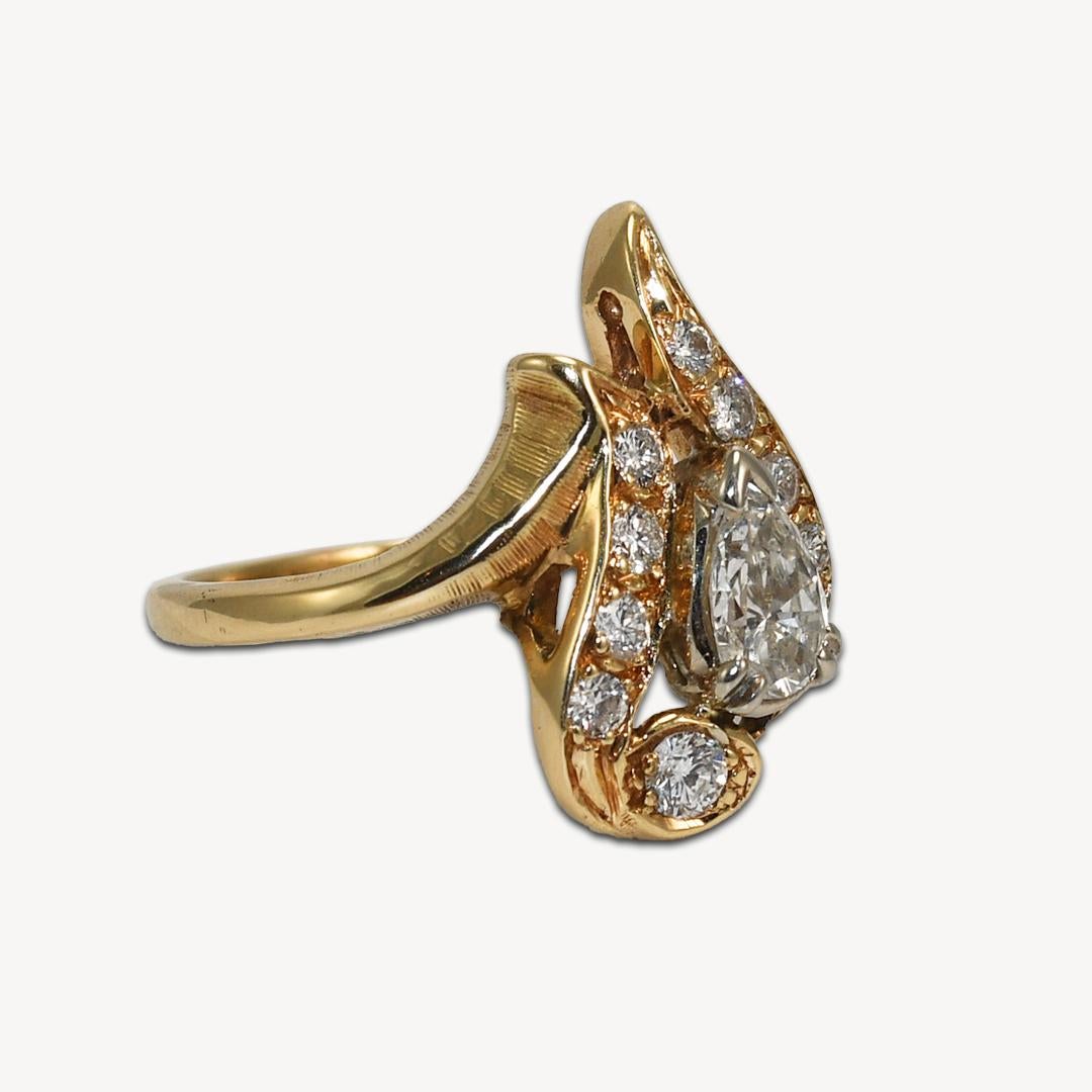 Pear shaped diamond ring in 14k yellow gold.
Stamped 14k and weighs 3.8 grams.
The center diamond is a pear shape, .50 carat, I color, VS clarity, very good cut.
On the sides are round brilliant cut diamonds, .32 total carats, F to G color, VS to Si