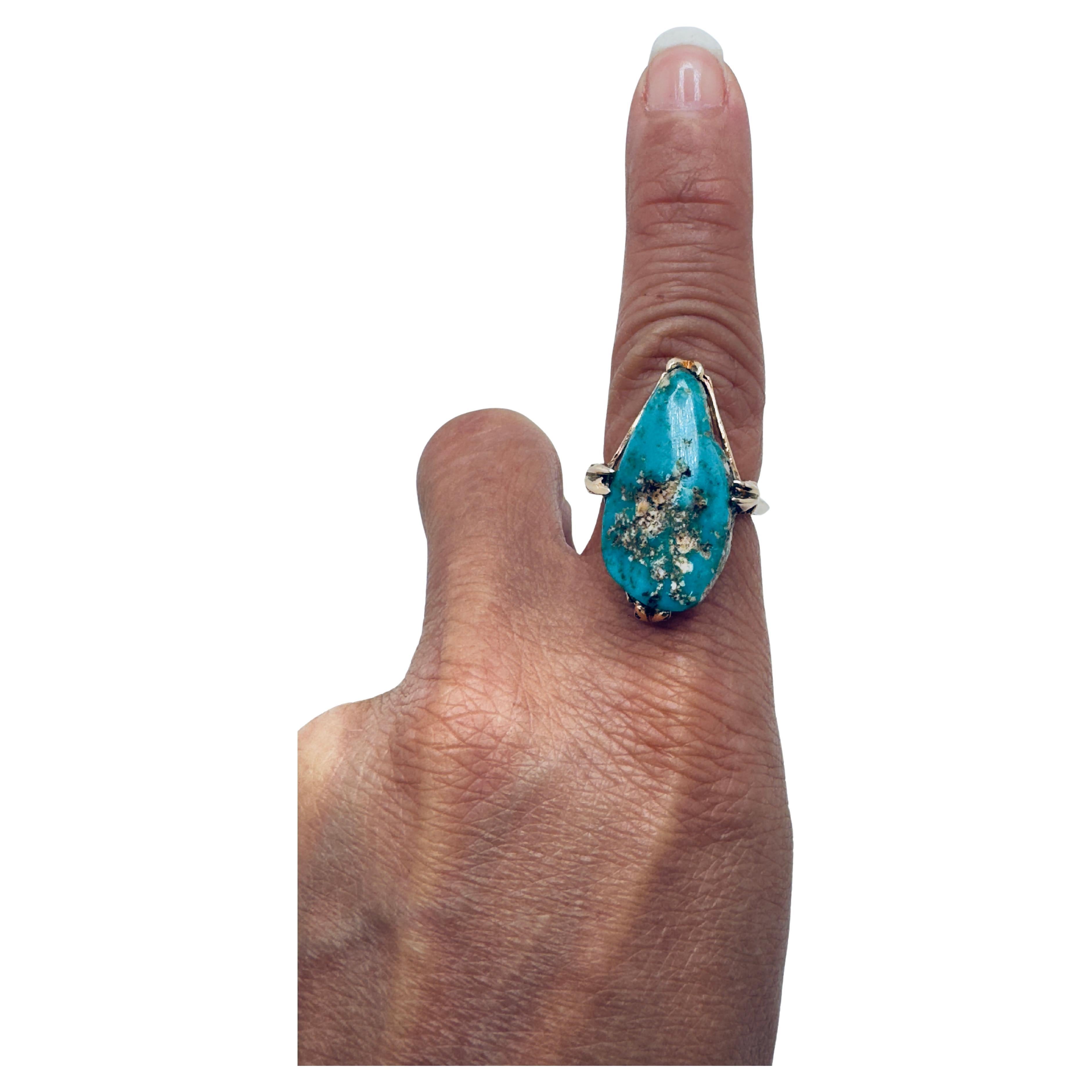 This elegant ring is beautifully crafted in 14K yellow gold, featuring a striking pear-shaped turquoise gemstone measuring 23x13mm. The turquoise displays a natural matrix pattern, giving it depth and unique character, making each piece one of a