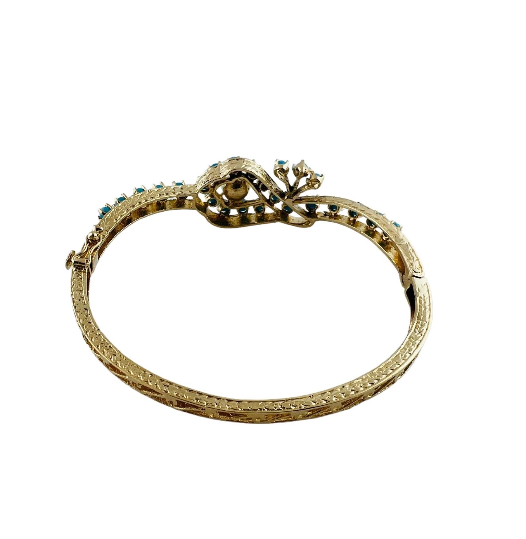 Vintage 18K Yellow Gold Pearl and Turquoise Bangle Bracelet

This ornate bracelet is set with 25 turquoise stones and 1 white pearl 

Turquoise stones are approx. 2mm in diameter and pearl is approx. 6 mm in diameter

Bracelet is approx. 6.5