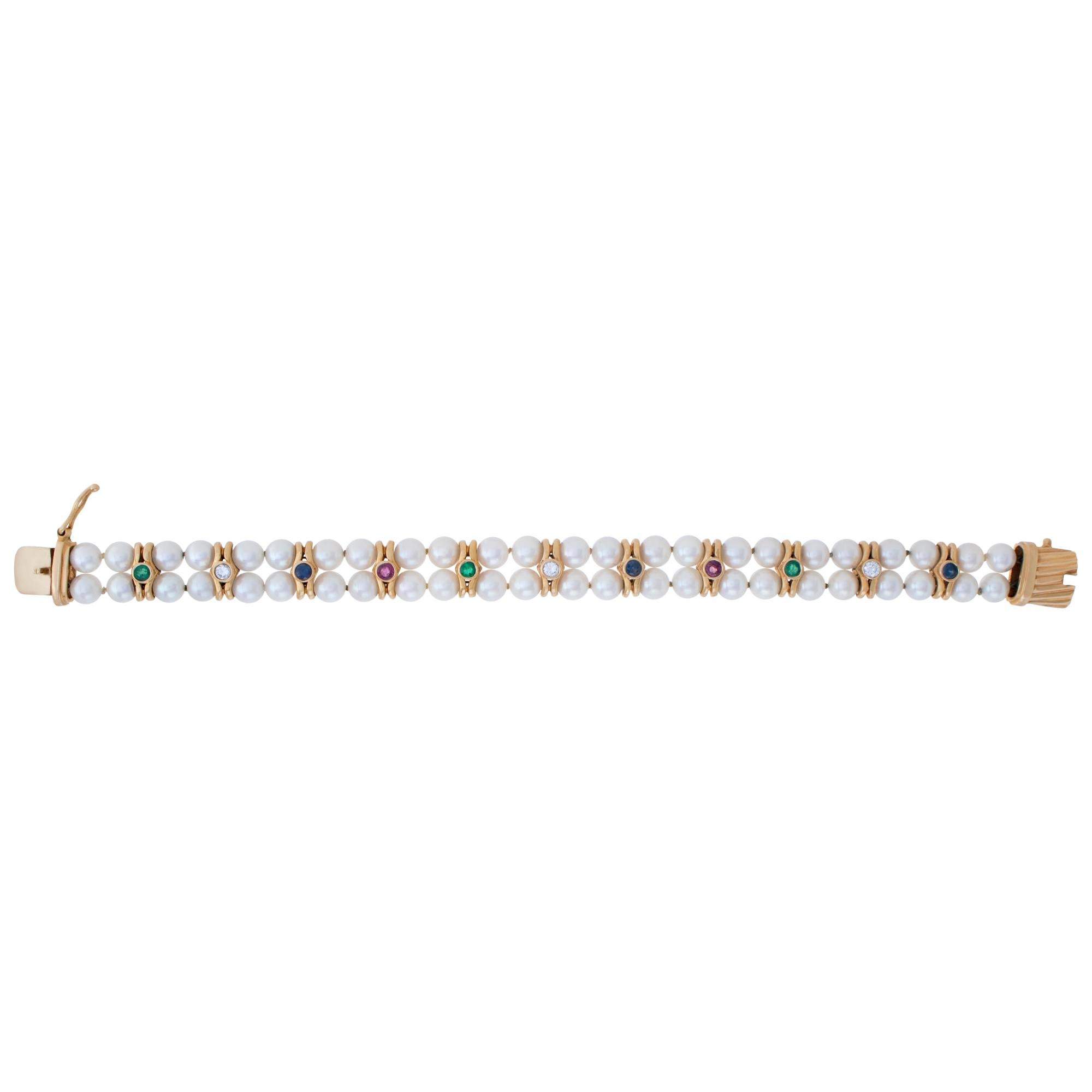 Pearl bracelet with rubies, diamonds, sapphires and emeralds in 14k yellow gold. Bracelet Length 7 inches, width 12mm.