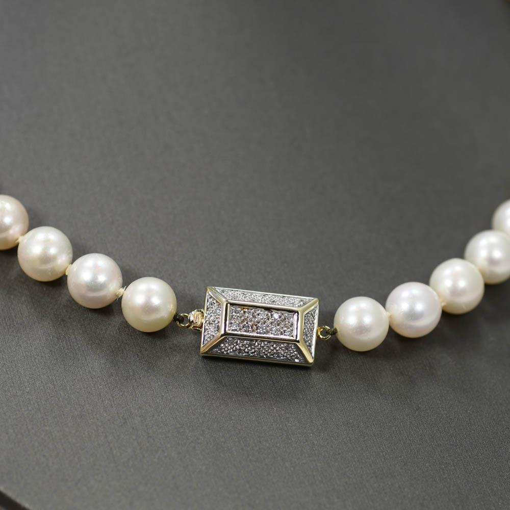 Saltwater cultured pearl necklace with 14k yellow gold and diamond clasp.
The clasp is stamped 14k and weighs 5 grams.
The clasp is set with small round diamonds, .20 total carats, i to j color, VS clarity. 
The pearls have a white body color with a