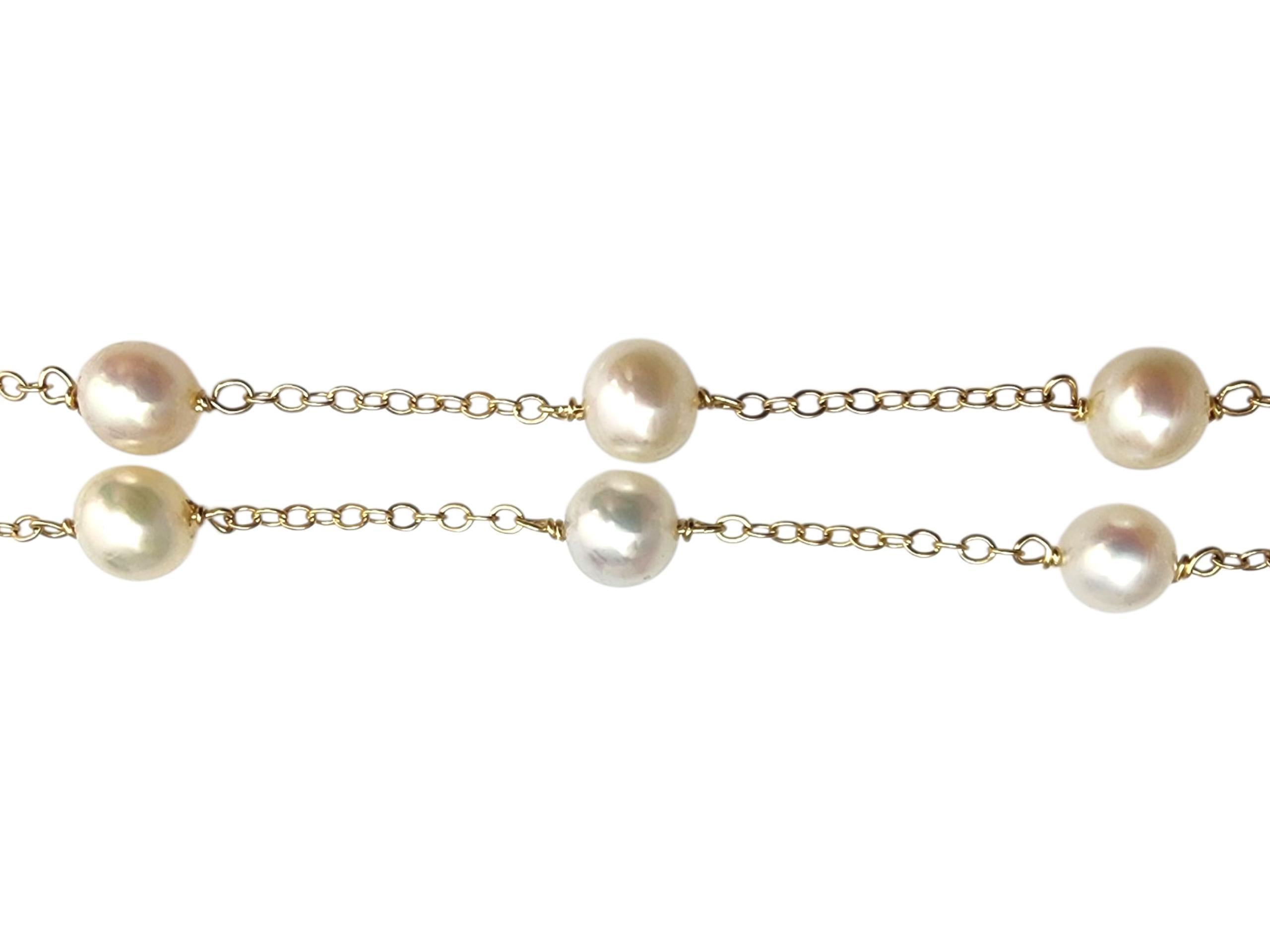 14K Yellow Gold Pearl Station Necklace-

Elegant and versatile, this pearl station necklace features lustrous cultured pearls evenly spaced along a delicate chain, offering a modern twist on a classic design perfect for layering or wearing
