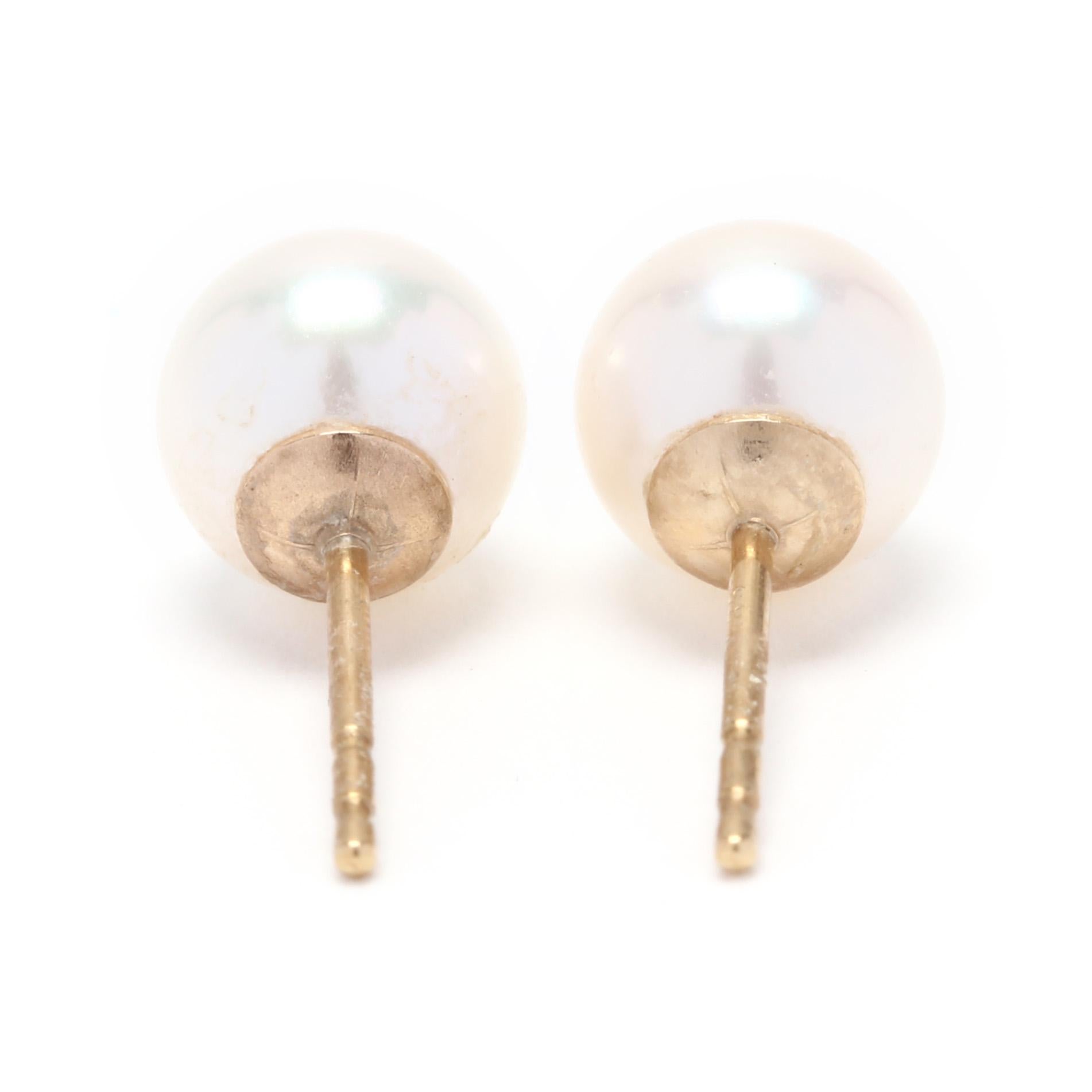 A pair of 14 karat yellow gold and pearl stud earrings. These earrings feature two round cream pearls (6.60 mm) with rose overtones, good luster and with push backs.

Stones:
- pearls
- round bead, 2 stones
- 6.60 mm

.92 dwts.

* Please note that