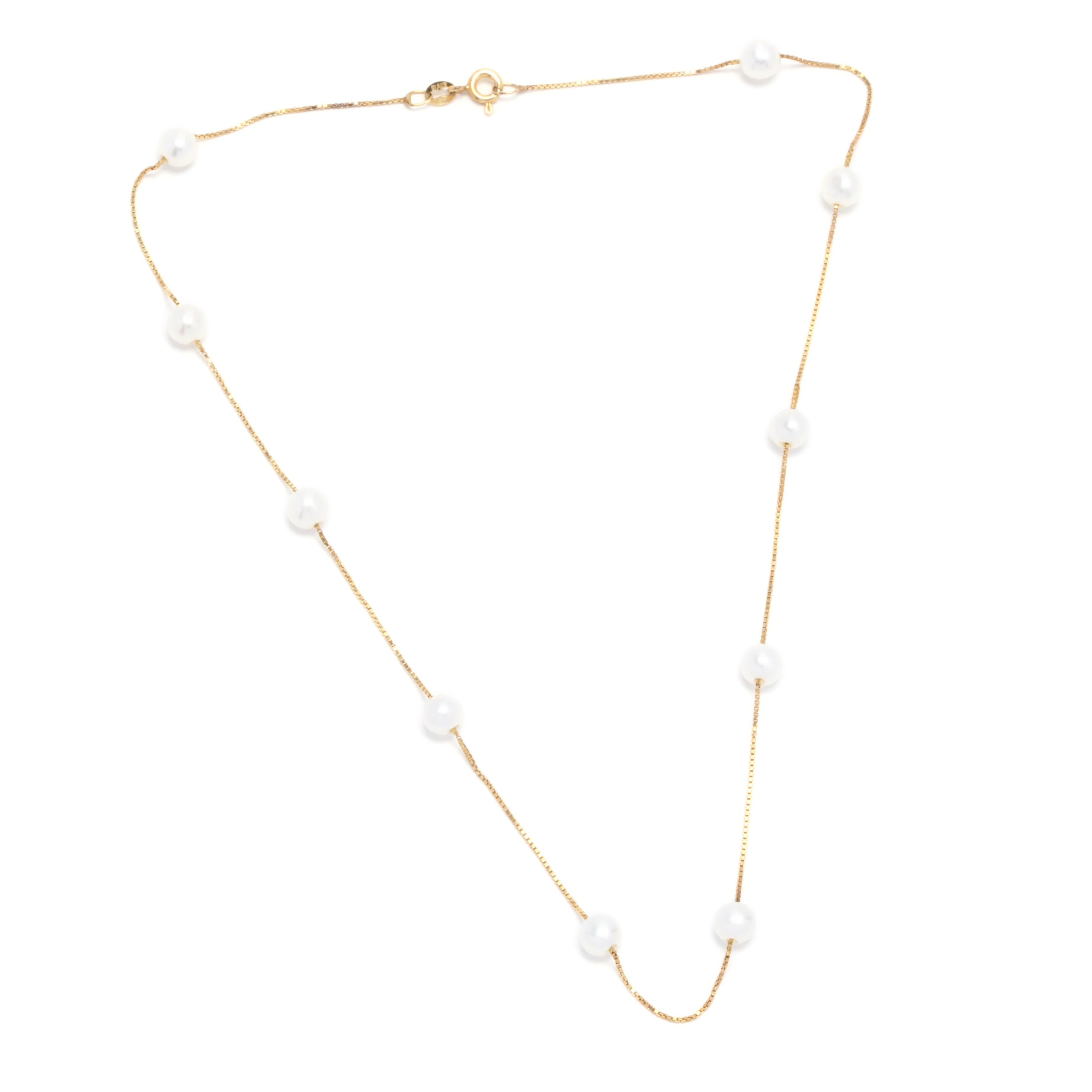 A 14 karat yellow gold and pearl tin cup necklace. A pearl by the yard necklace with 10 round white pearl stations set on a thin box chain and a spring ring clasp.

Stones:
- pearls
- round beads, 10 stones
- 5.4 - 5.7 mm

Length: 16 in.

2.33