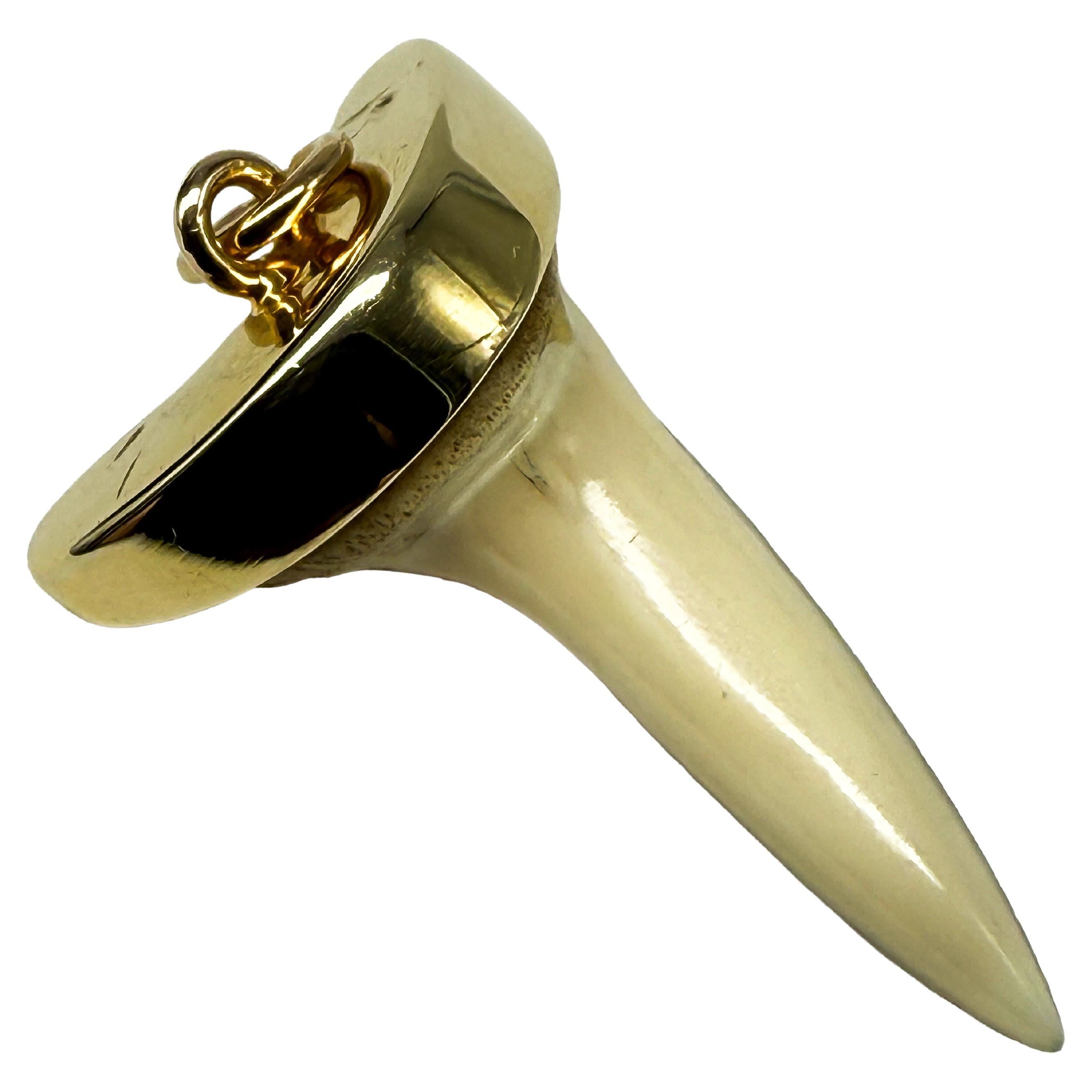 14K yellow gold pendant with a shark tooth