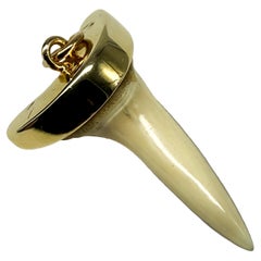 14K yellow gold pendant with a shark tooth