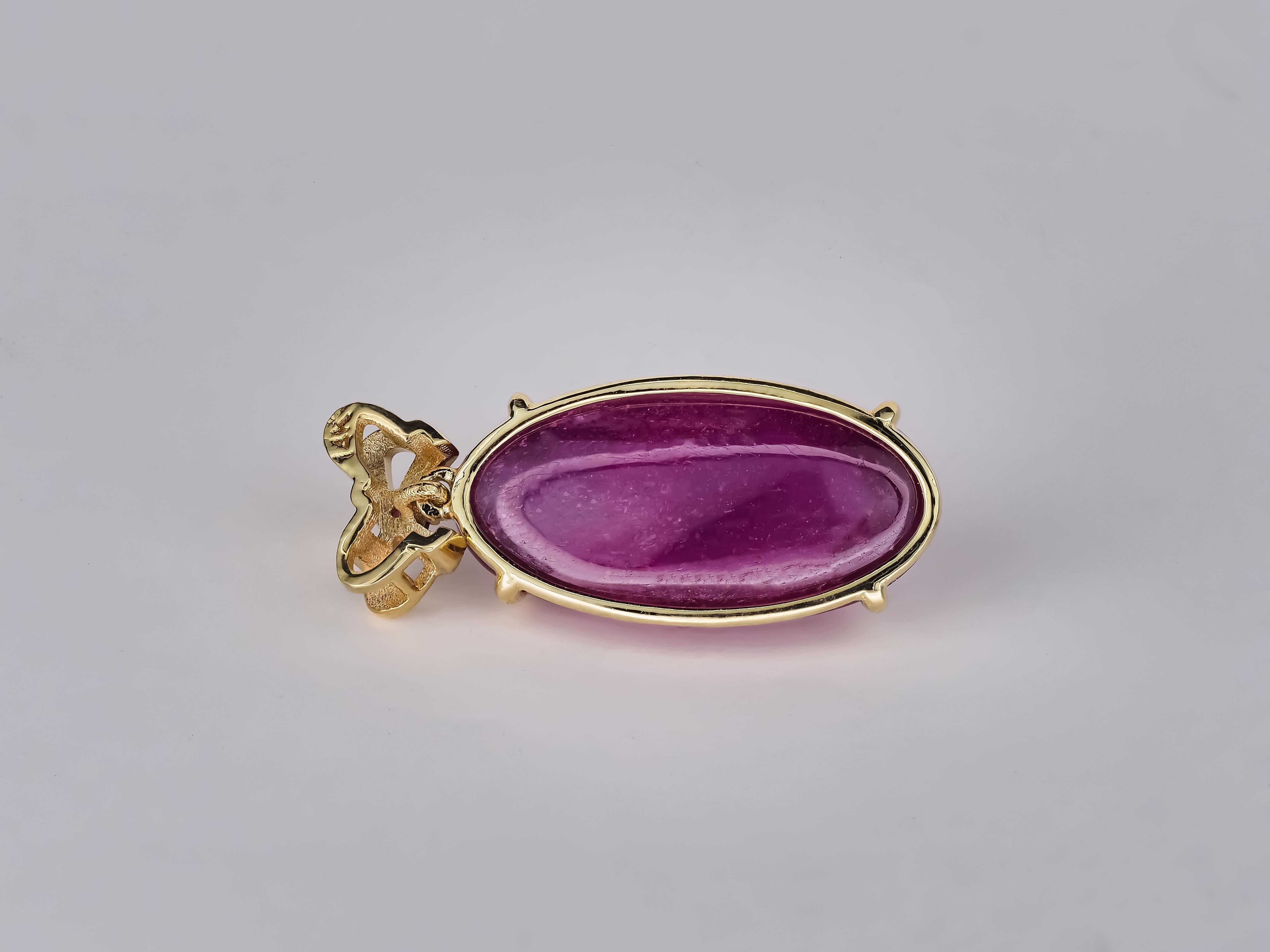 14k yellow gold pendant with natural oval cabochon ruby reddish pink color and pink sapphire. 

Selling only pendant without necklace.
Total weight: 3.65 gr.
Size: 24.8x10.3x5.6 mm.

Gemstones:

Ruby, color - reddish pink, oval cabochon cut (approx.