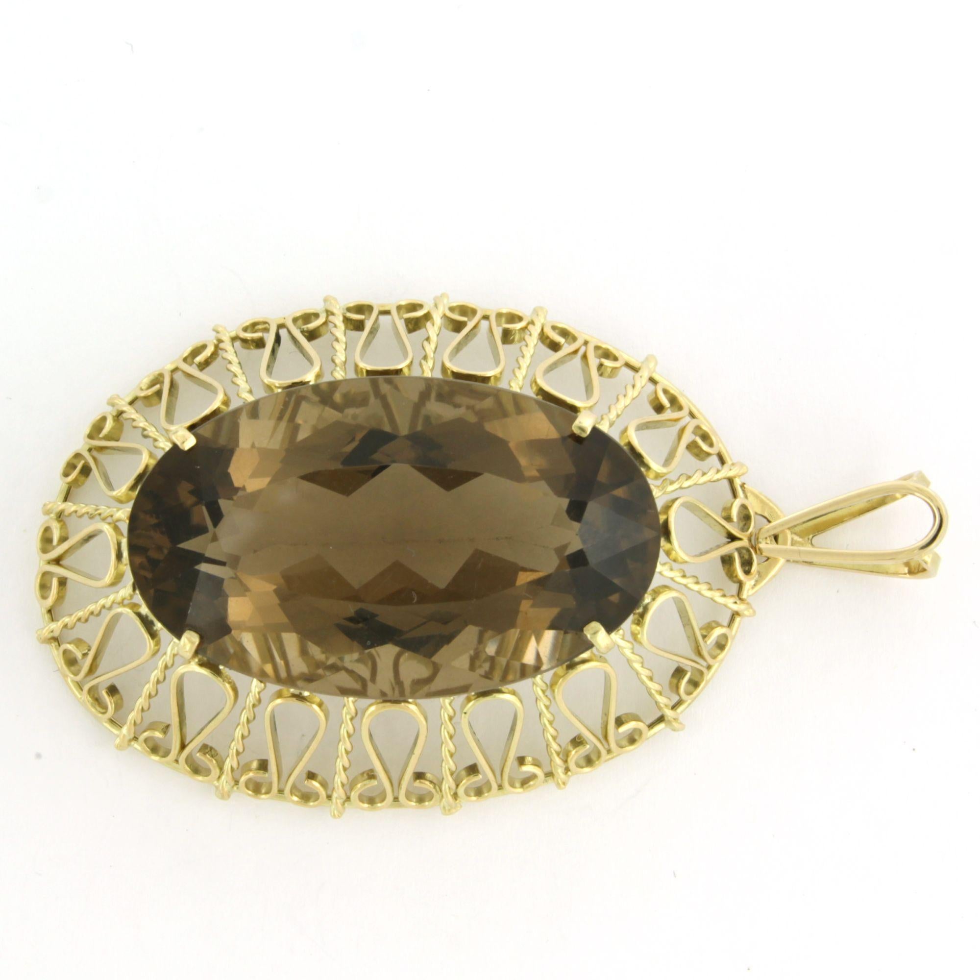 14k yellow gold pendant set with smoky quartz, totaling approximately 60.00 ct – 21.3 grams

Detailed description

The pendant measures 6.4 cm high by 3.6 cm wide.

Total weight: 21.3 grams

Set with:

- 1 x 3.6 cm x 2.1 cm oval facet-cut quartz,