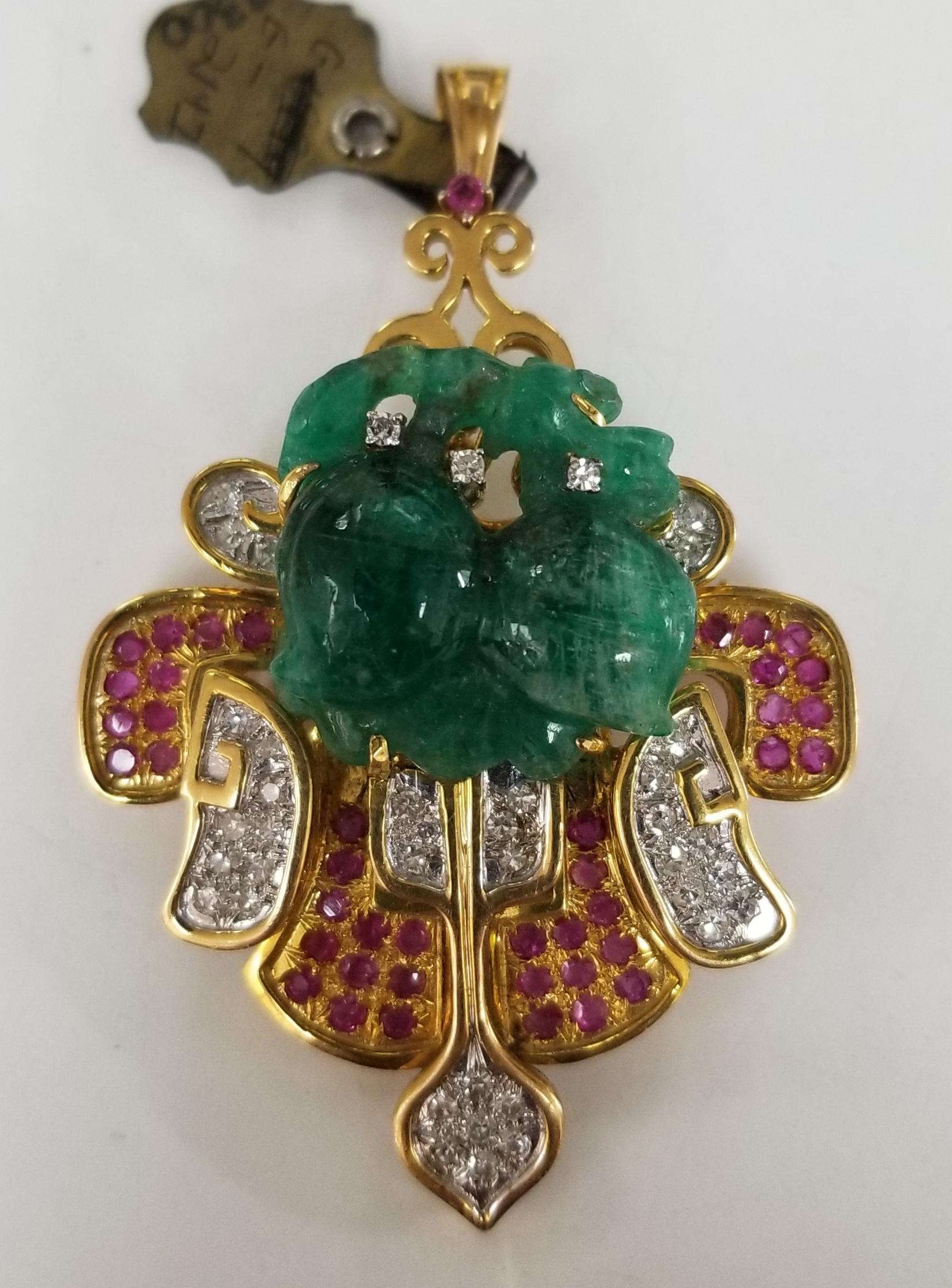 This piece of fine jewelry was designed and hand crafted by “Moshi” of New York, it was found in a vault from an estate sale and was never used.  14k yellow gold pin/pendant with hand craved emerald weighing 21.47cts. and 36 round single cut