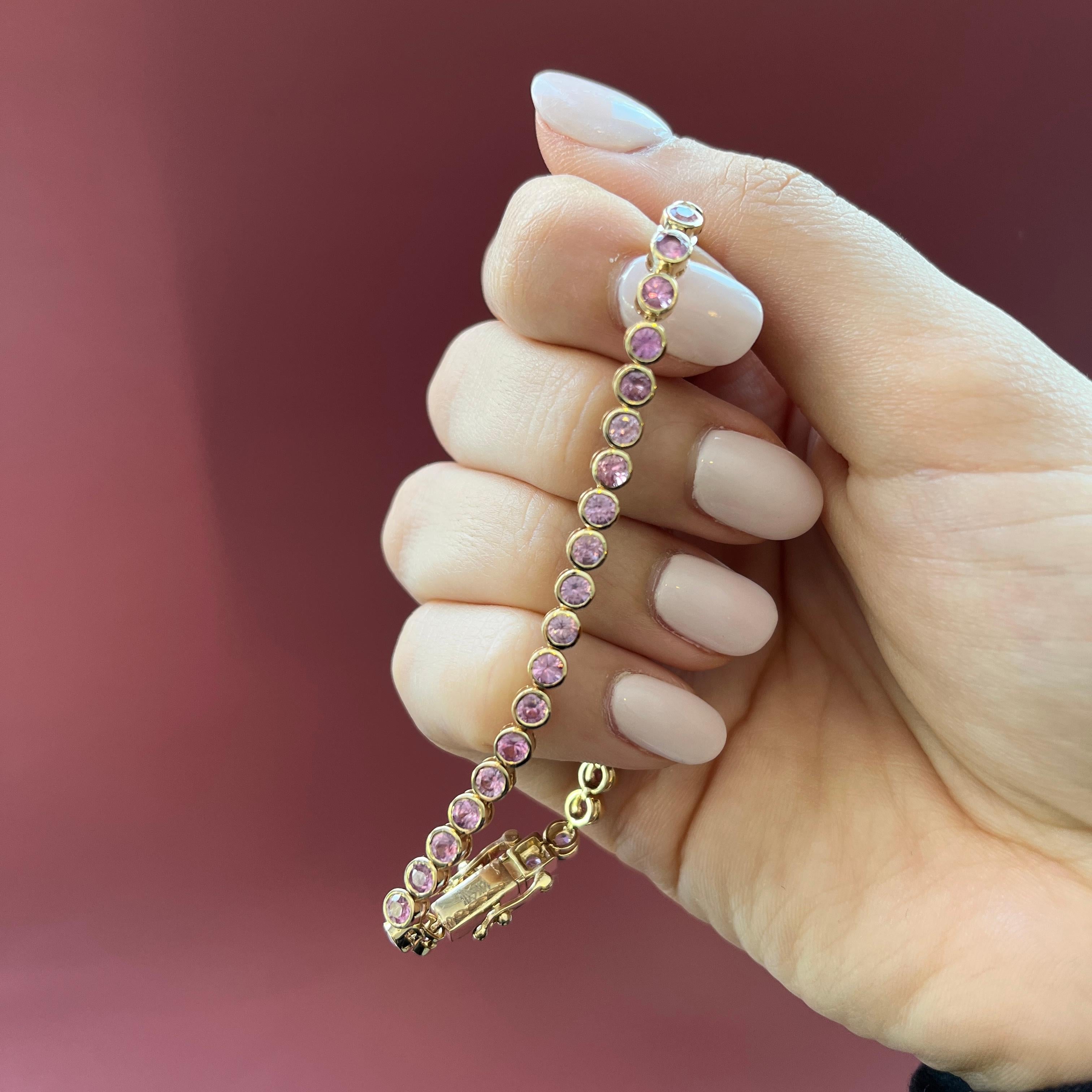 Experience timeless elegance with this stunning tennis bracelet, boasting beautiful Pink Sapphires in a sleek bezel setting. Perfect for any occasion, this piece exudes sophistication and class.

14K Yellow Gold
44 Round Pink Sapphires at 6.37