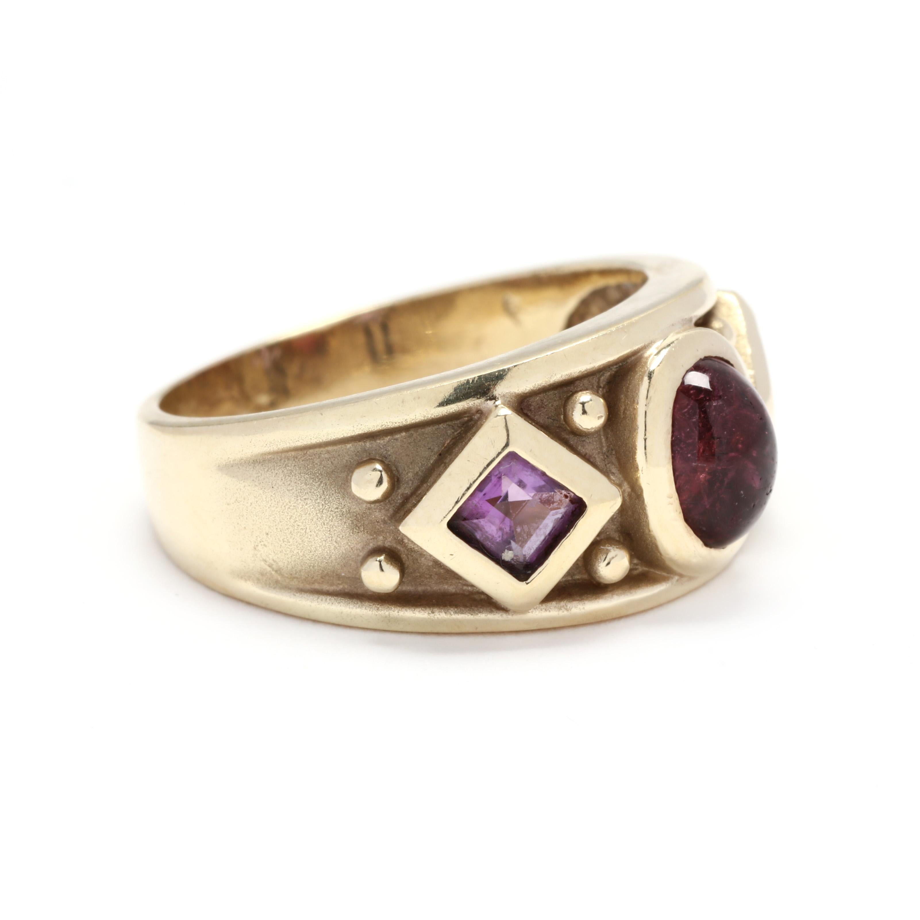Vintage 14 karat yellow gold, pink tourmaline and amethyst wide band ring. A tapered band design centered on a bezel set, oval cabochon cut pink tourmaline weighing approximately 1.20 carats with a square cut amethyst on either side weighing