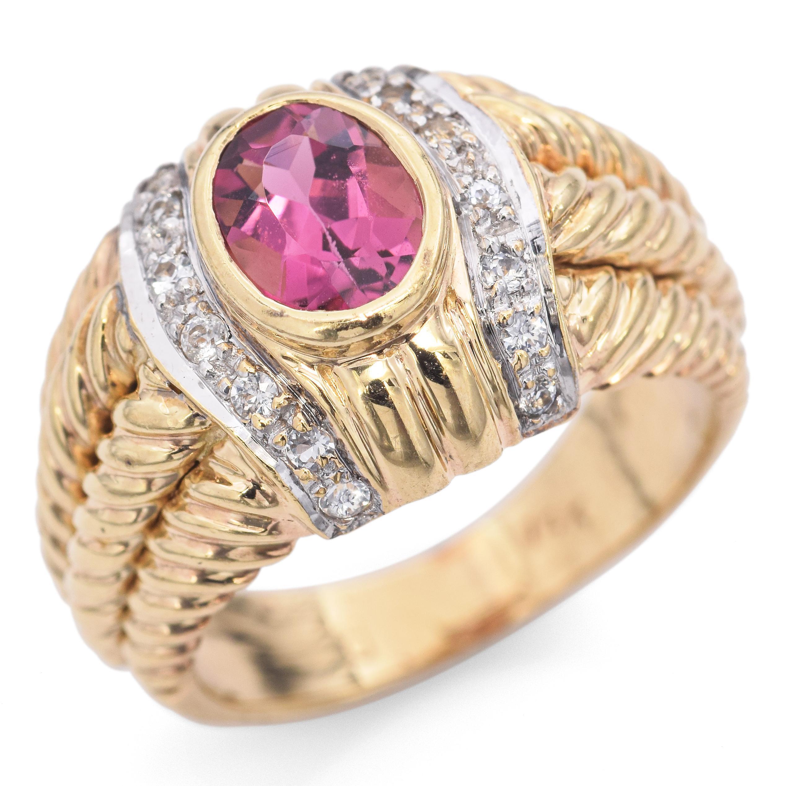 Exquisitely crafted in gold, this striking ring features a vibrant oval-cut pink tourmaline at its center, flanked by a dazzling array of small round diamonds. The band showcases a bold, ribbed design, enhancing its luxurious appeal.

Weight: 7.4