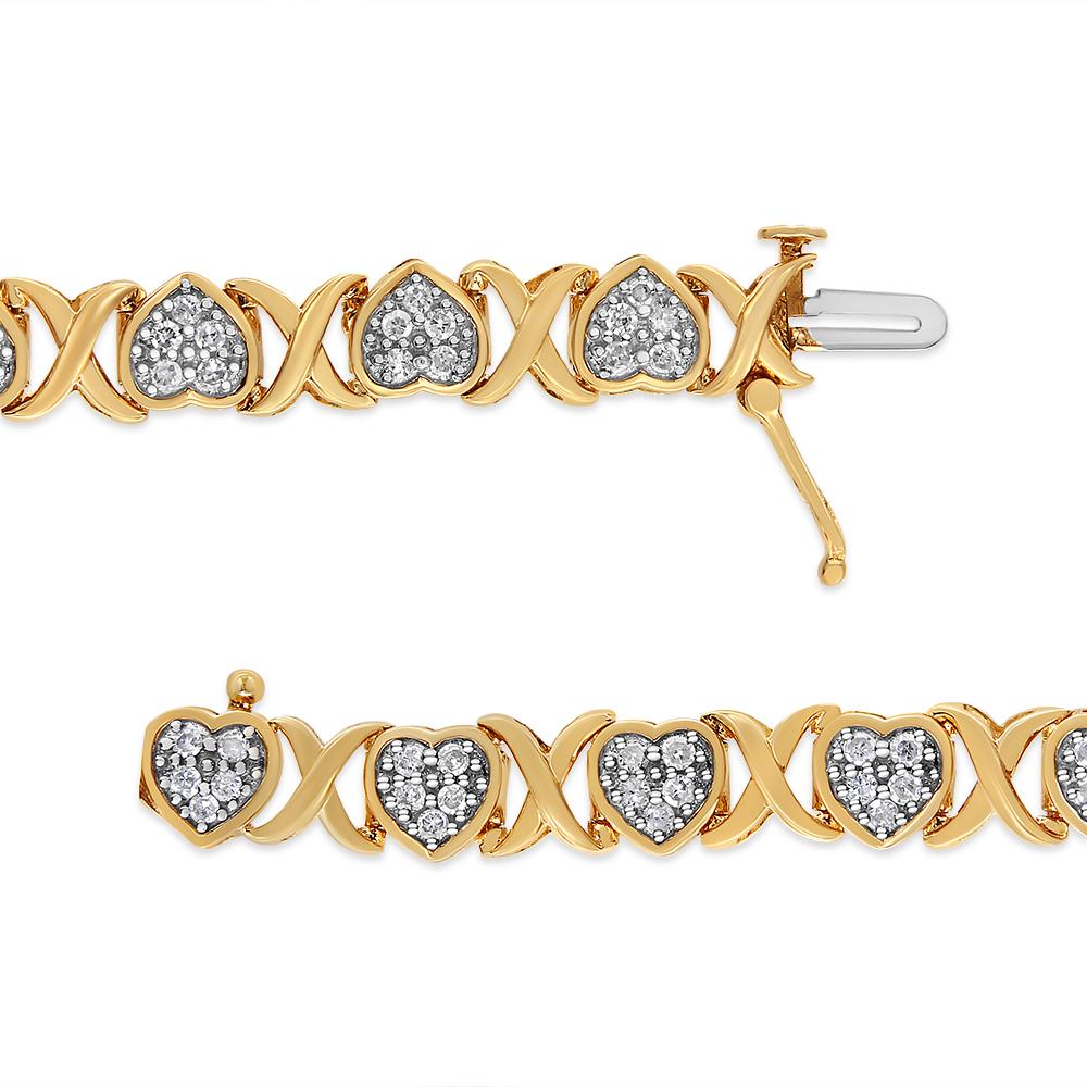 Introducing a breathtaking masterpiece that will steal your heart! This exquisite 14KY Yellow Gold Plated .925 Sterling Silver bracelet showcases a mesmerizing design of intertwining hearts and X links, symbolizing eternal love and unity. Adorned