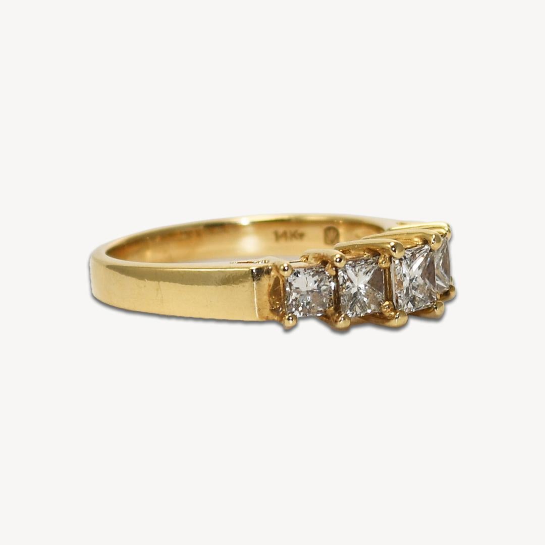 14K yellow gold diamond ring.
Marked 14k and weighs 3.4 grams.
There are five princess cut diamonds, 1.00 carats total weight, i to j color, vs-SI1 clarity.
Well-made, attractive, and in excellent condition.
The ring size is 6 1/2 and can be sized