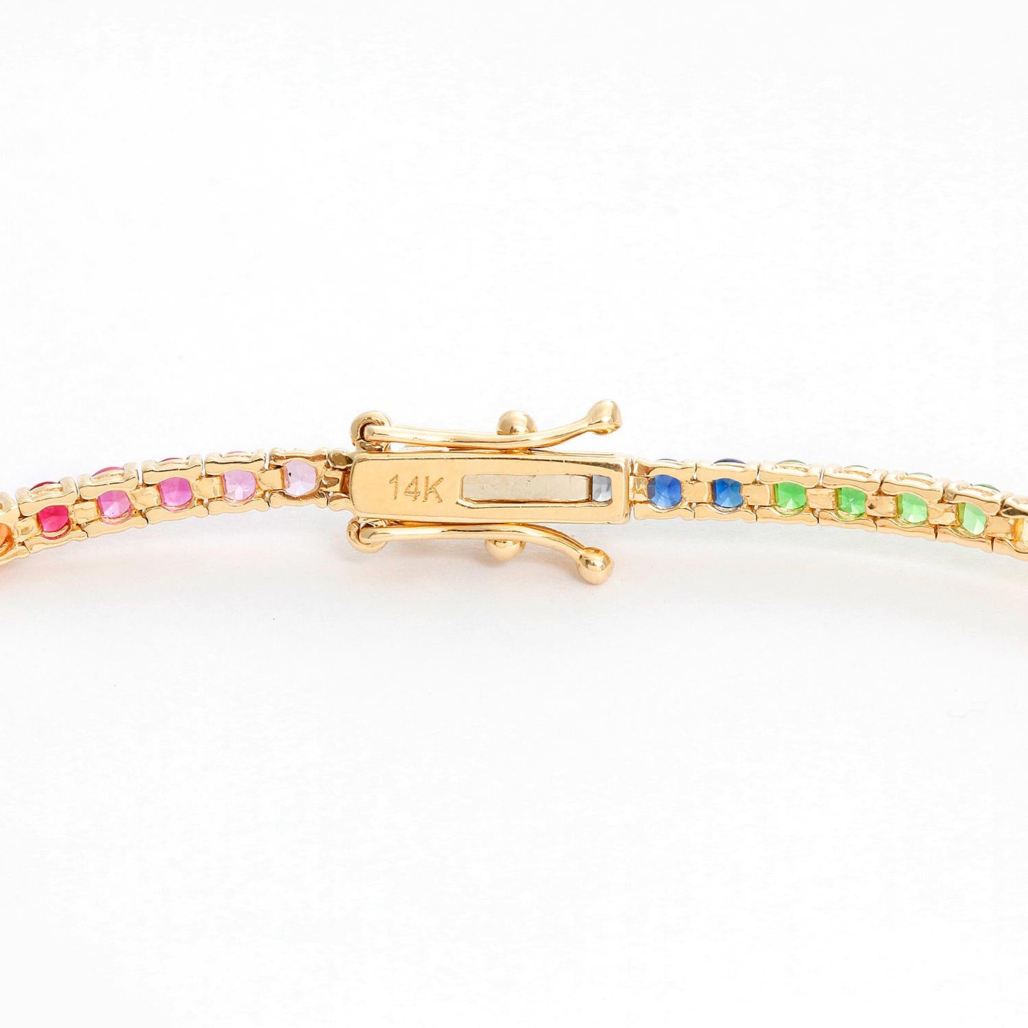 14K Yellow Gold Rainbow Sapphire Bracelet - Beautiful 4.08 cts of rainbow Sapphires. This tennis bracelet features a multicolored gradient of 2.37mm round brilliant sapphires.  Total weight 6.5 grams. Wrist size up to 7 inches .